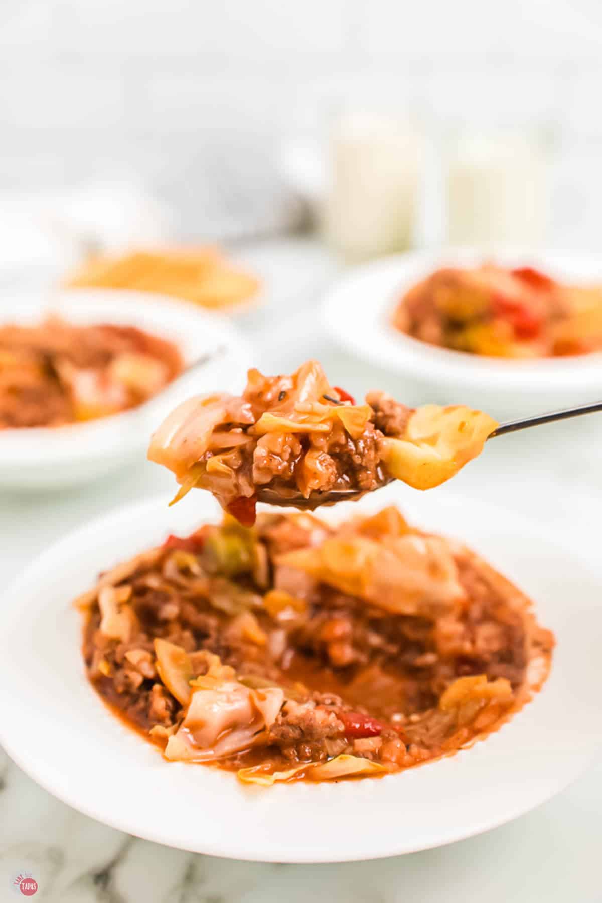 spoon filled with stuffed cabbage soup