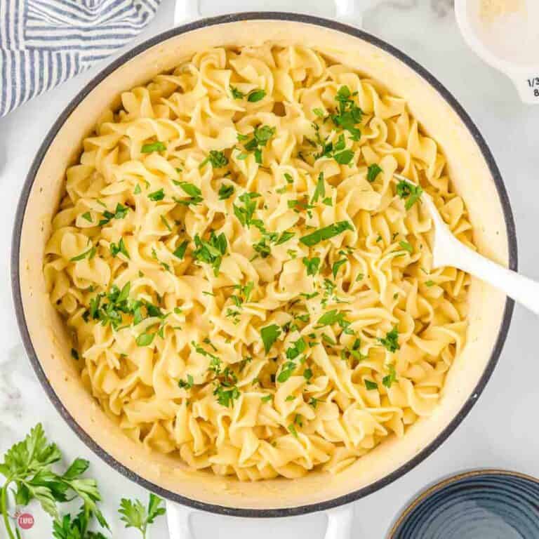 large pot of cafeteria noodles topped with parsley