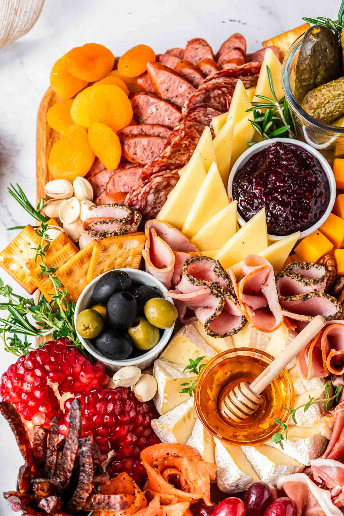close up of meat and cheeses around small bowls