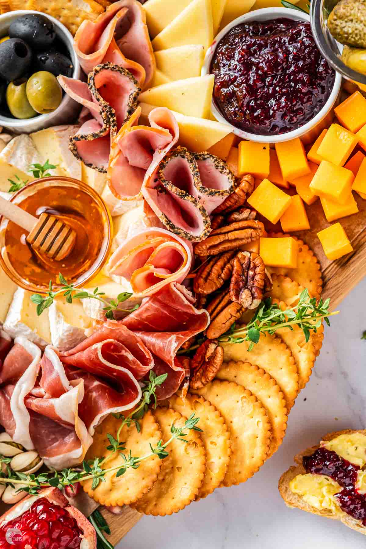 close up of cheese and crackers on a board