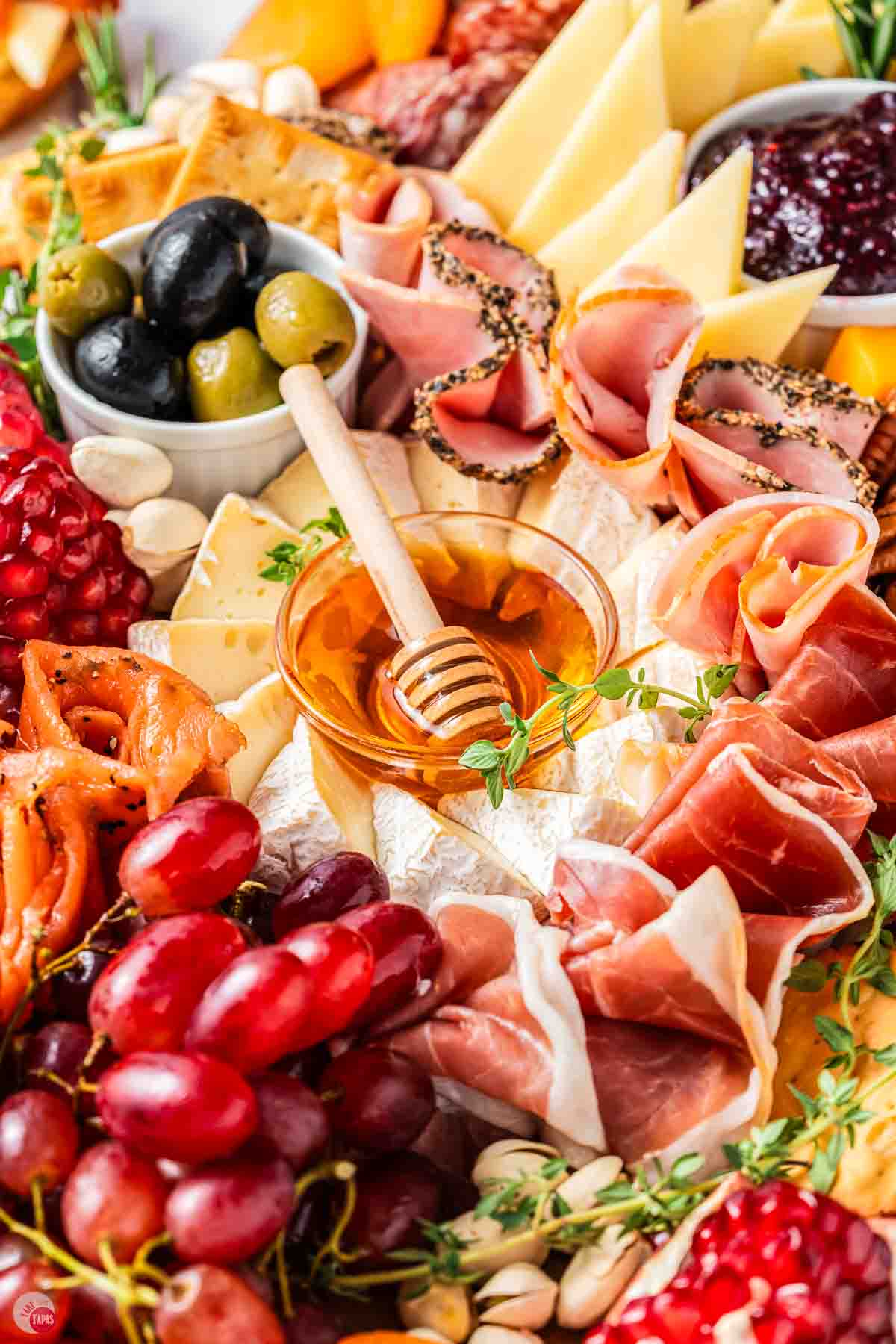 close up of cheese and a bowl of honey