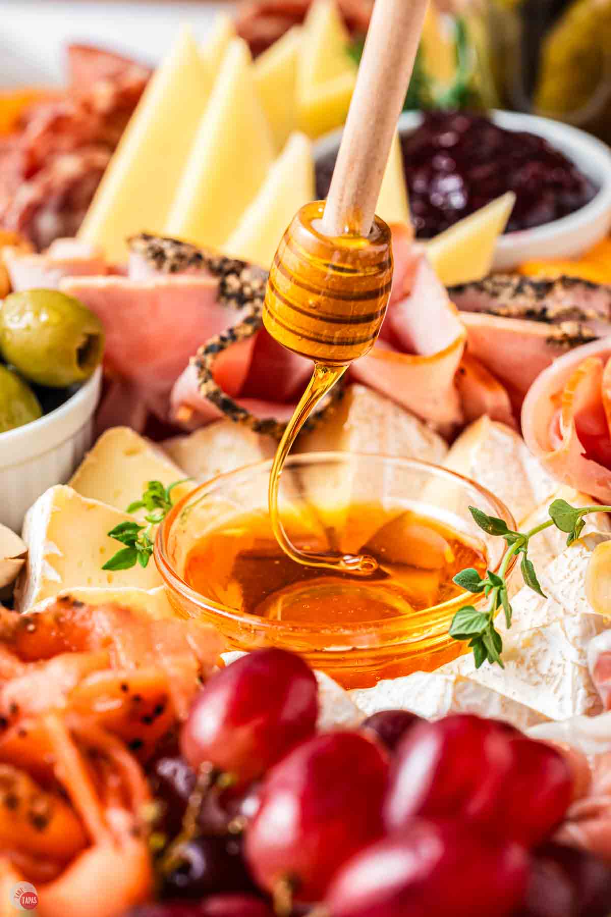 bowl of honey with some being drizzled