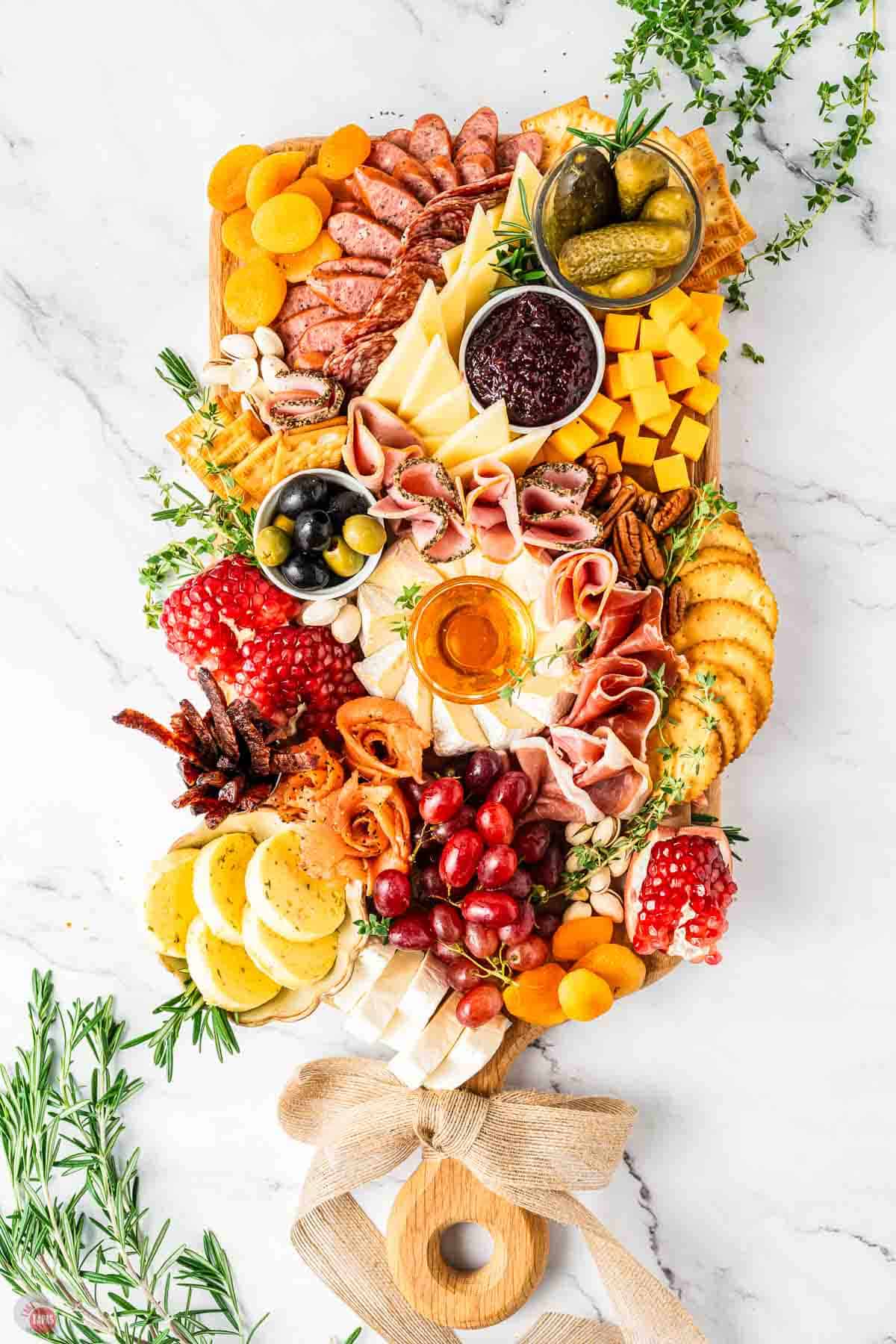 cheese board with crackers and garnishes