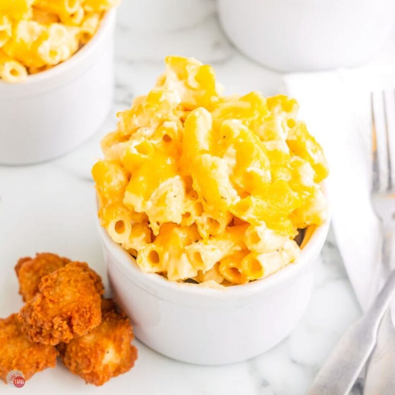 small bowl of Chick Fil A Macaroni and Cheese next to four chicken nuggets