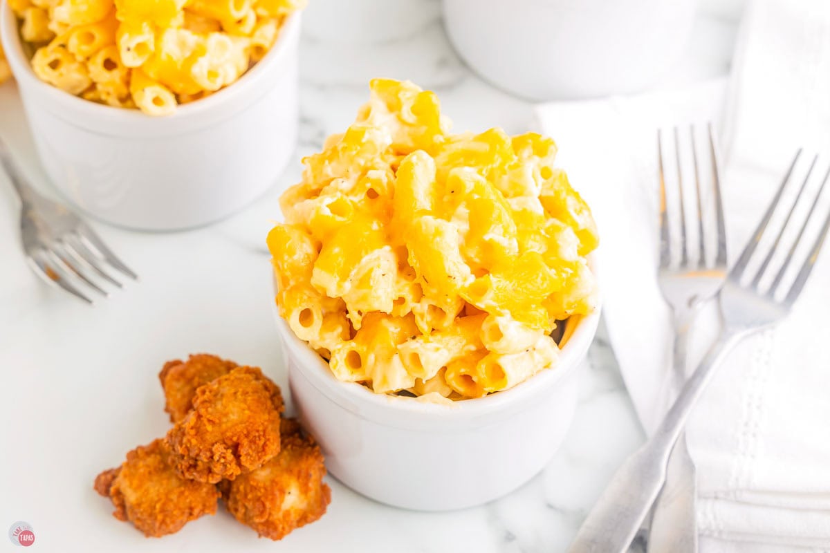 small ramekin with mac and cheese and chicken nuggets next to it