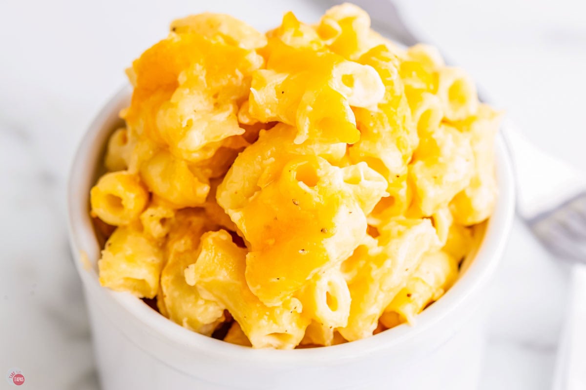close up of macaroni noodles with baked cheese on top