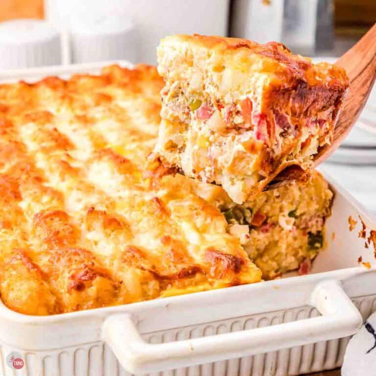 white baking dish with a scoop of food missing