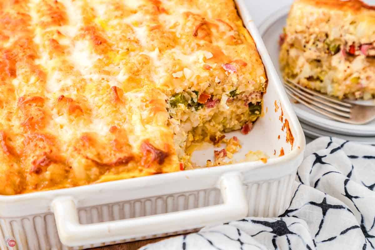 white baking dish with a scoop of the recipe missing