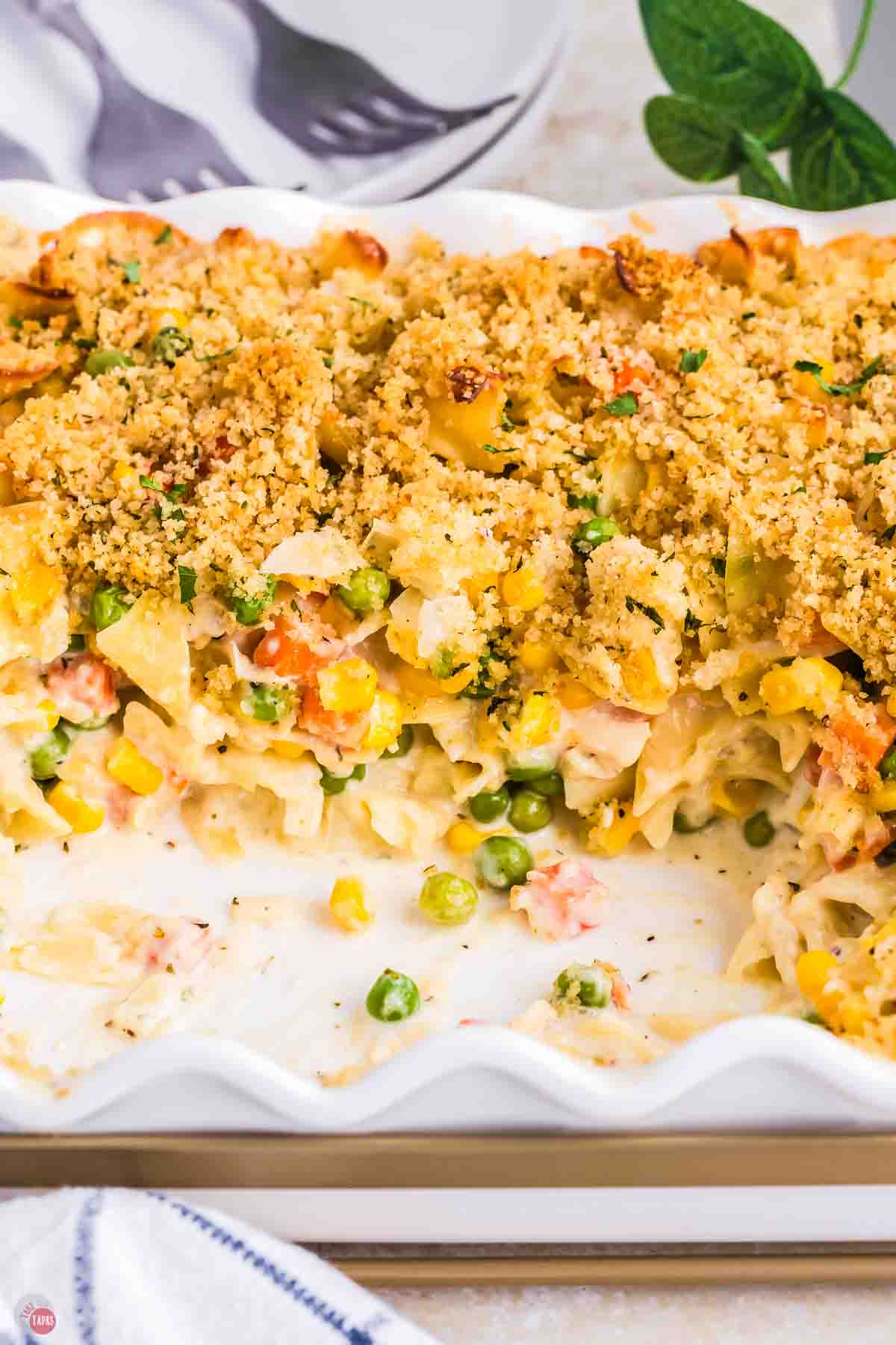 casserole with a scoop missing in a white dish