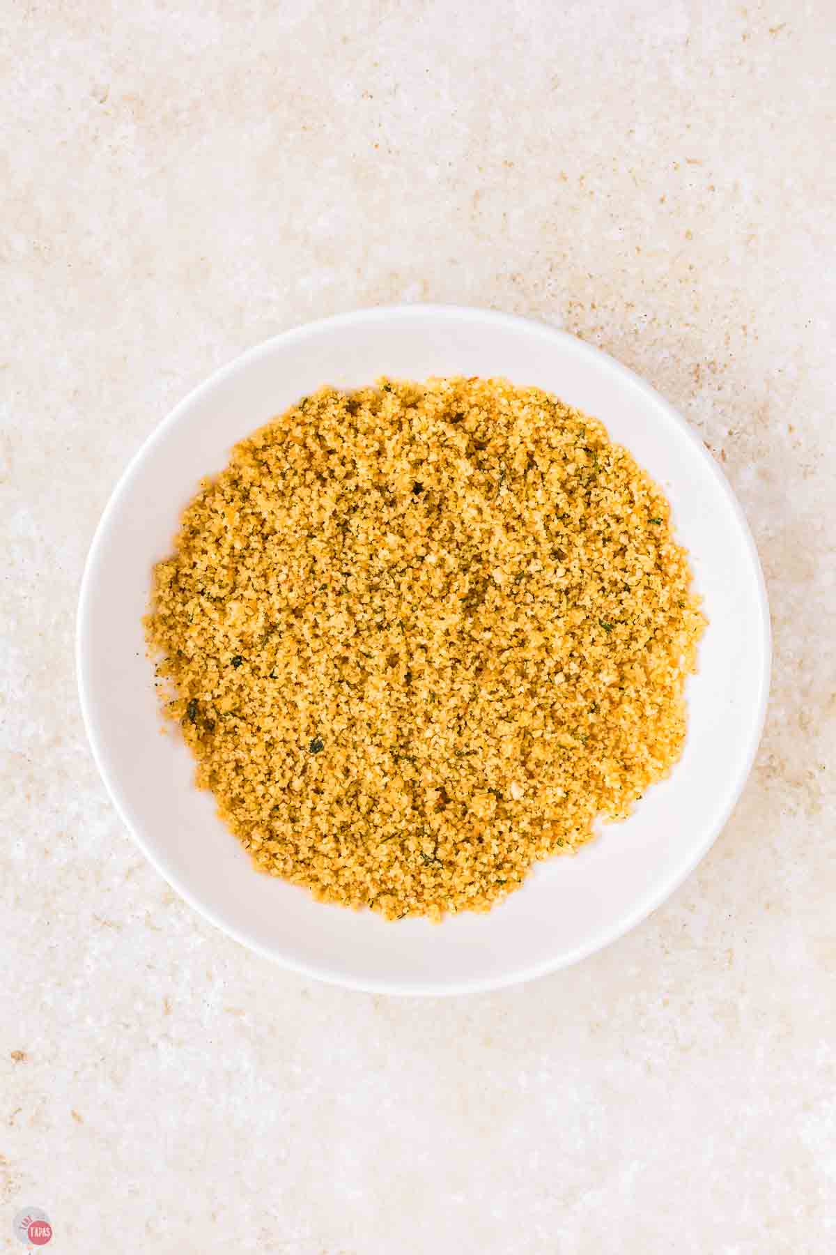 melted butter and breadcrumbs in a white bowl