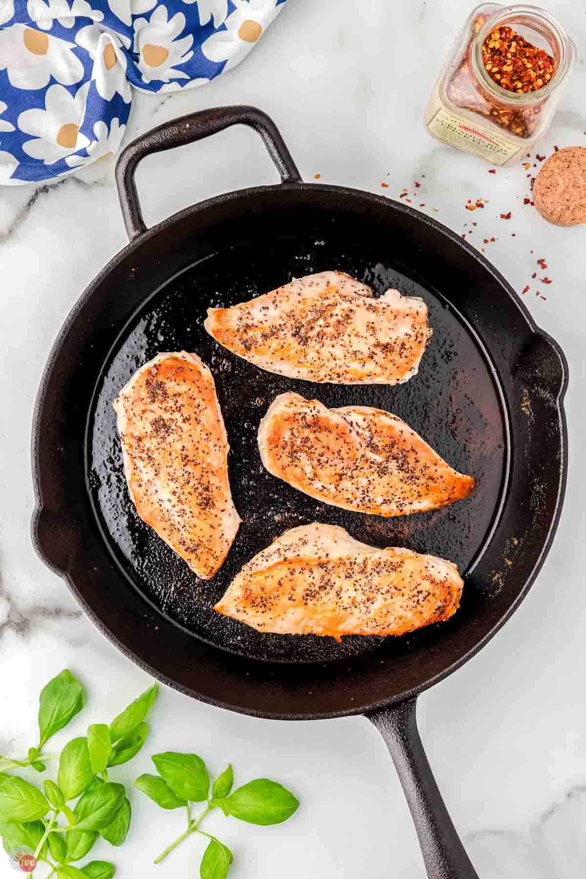 cooked chicken breasts in a cast iron skillet