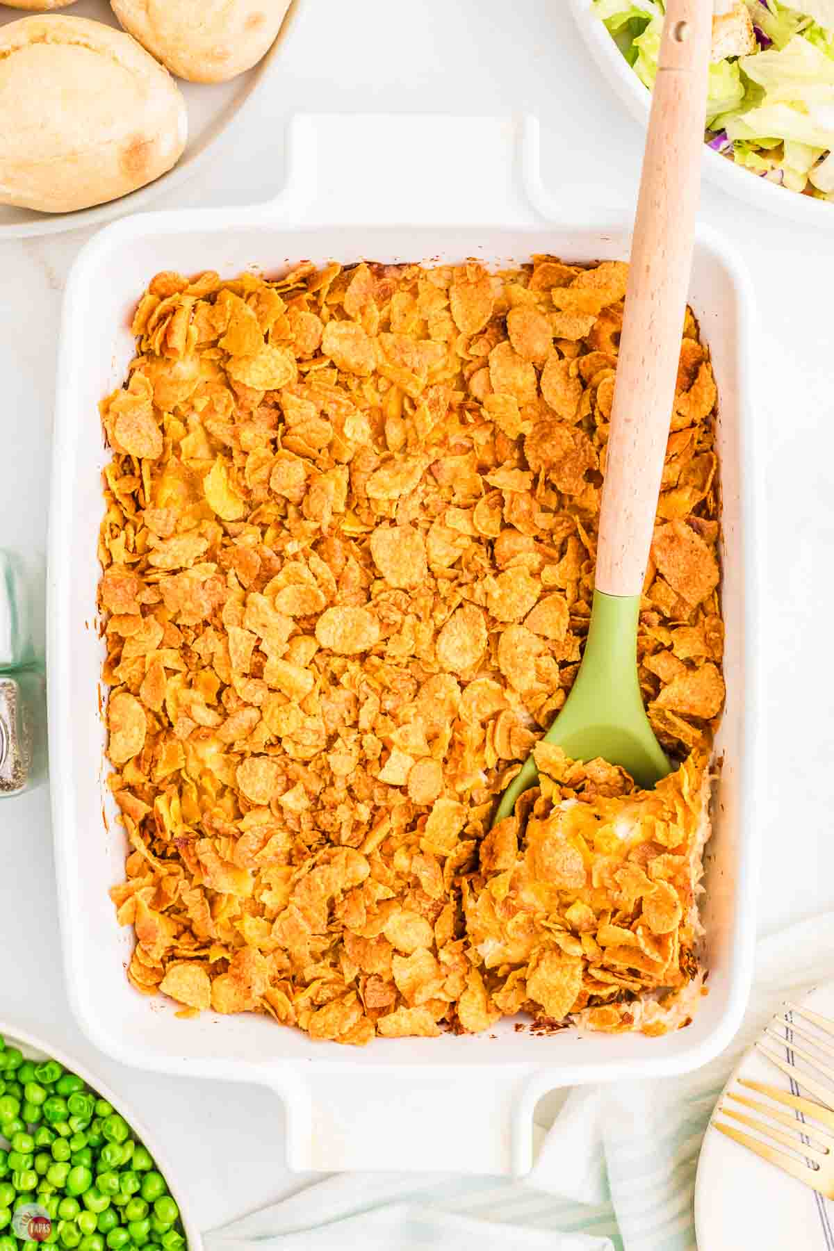baked casserole with a green spatula in it