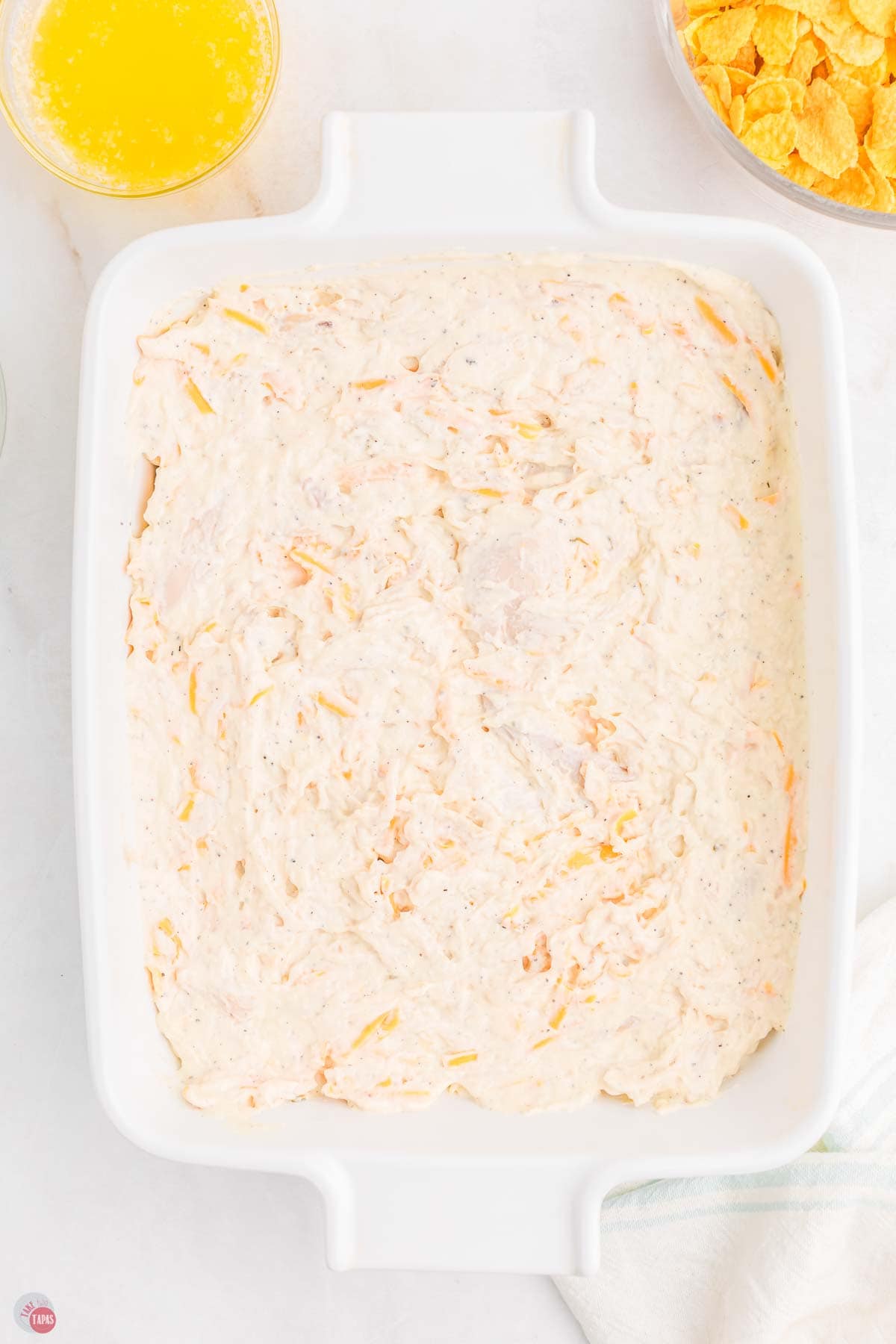 chicken mixture spread in a white baking dish