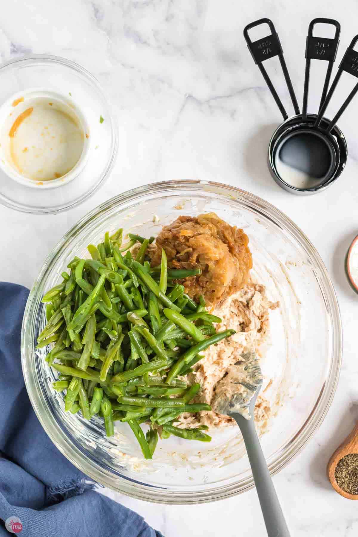 green beans, spices, and shredded chicken in a clear bowl