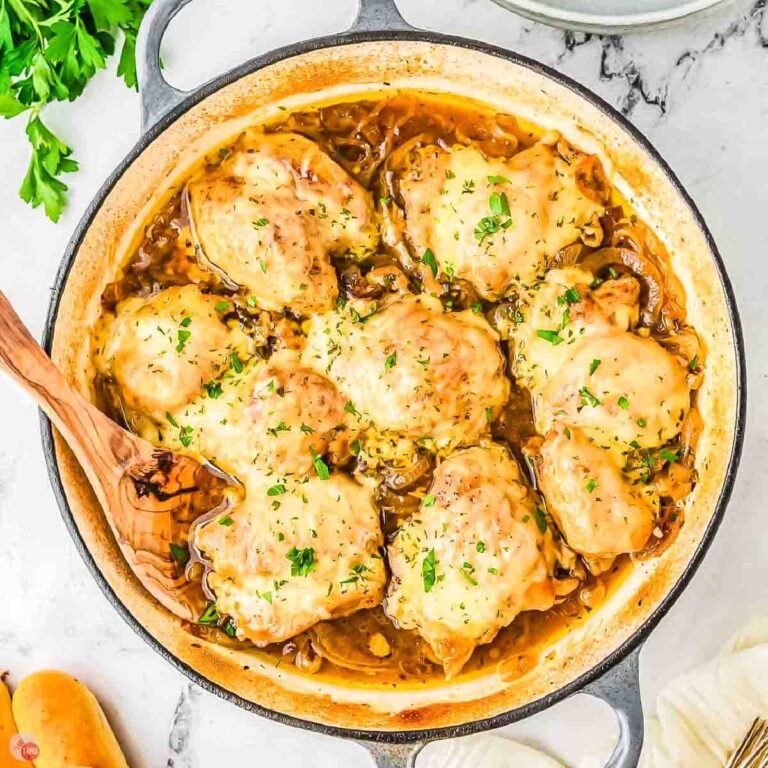 skillet full of french onion chicken with wood spoon