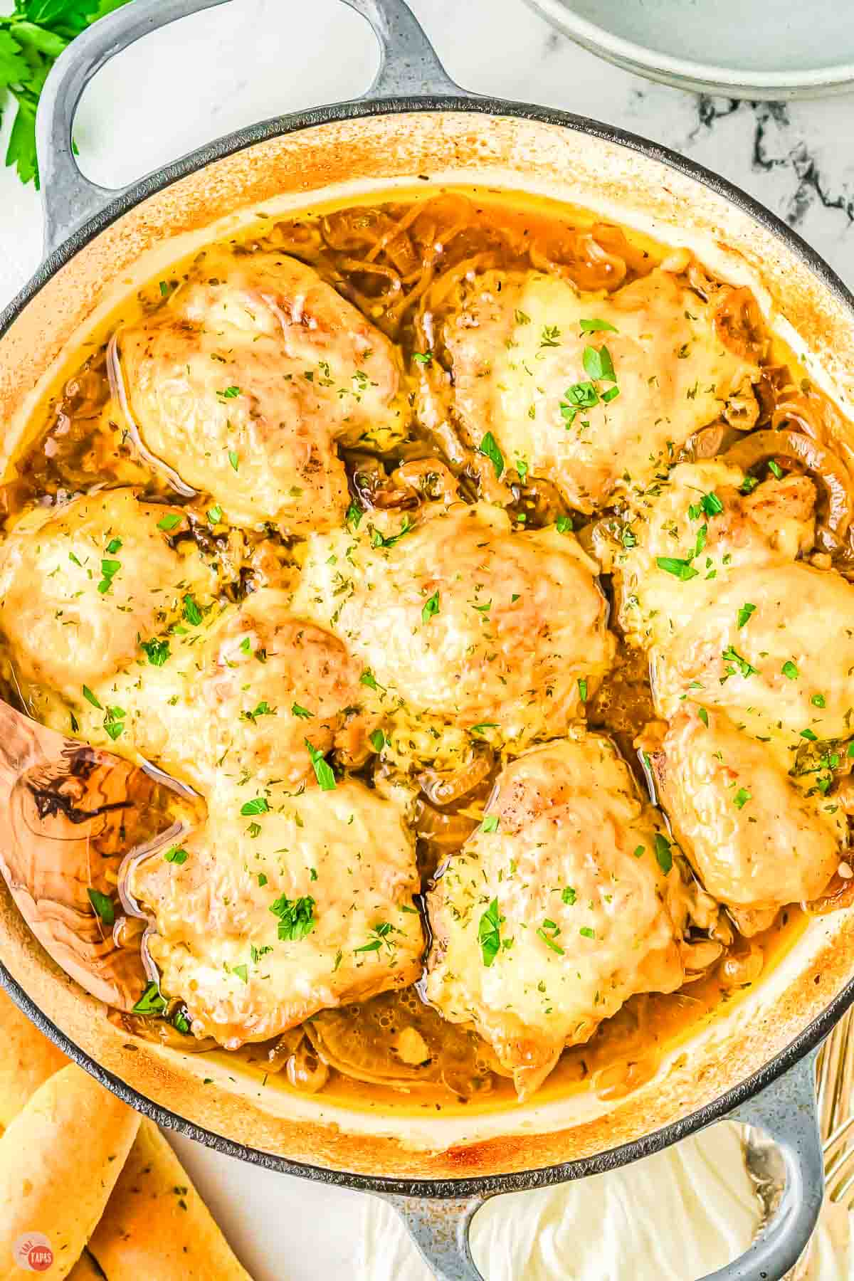 baked french onion soup chicken topped with chopped parsley