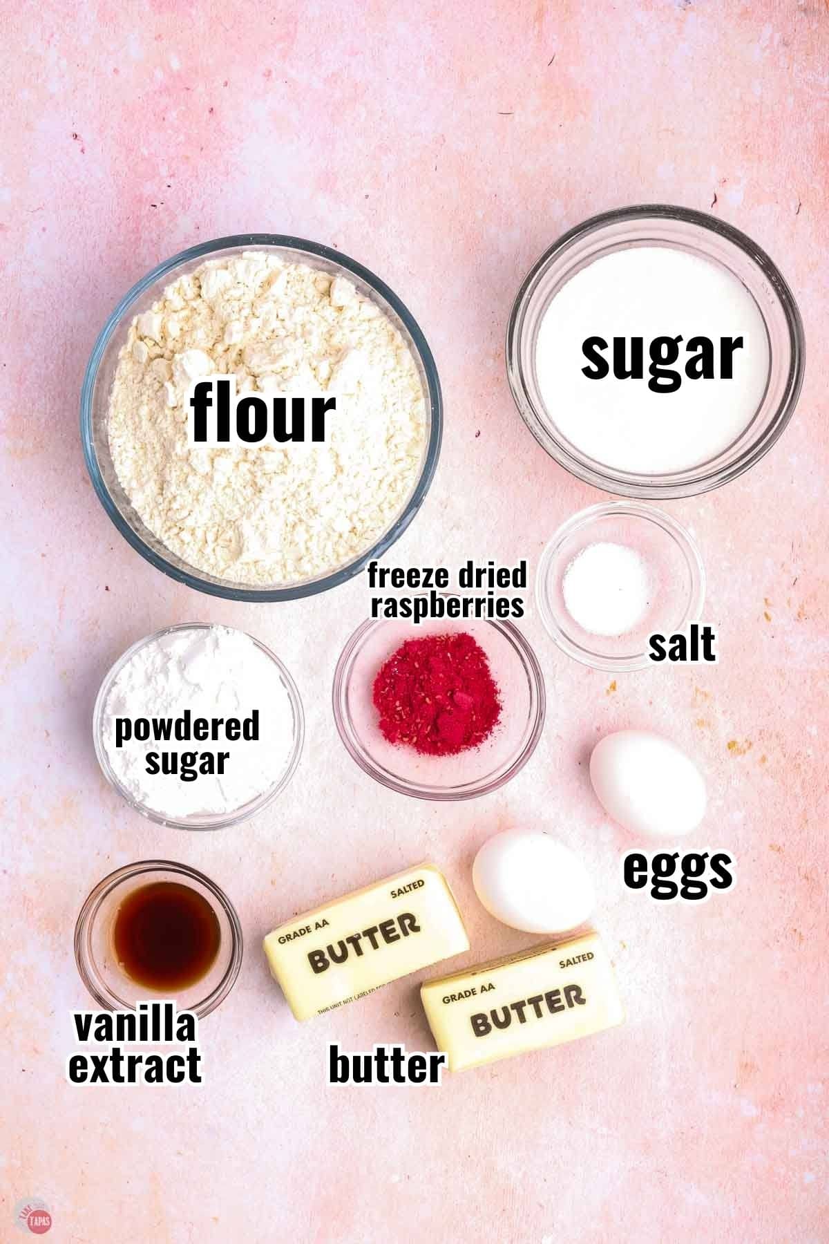 ingredients for a cookie recipe in individual bowls with text overlay labeling them