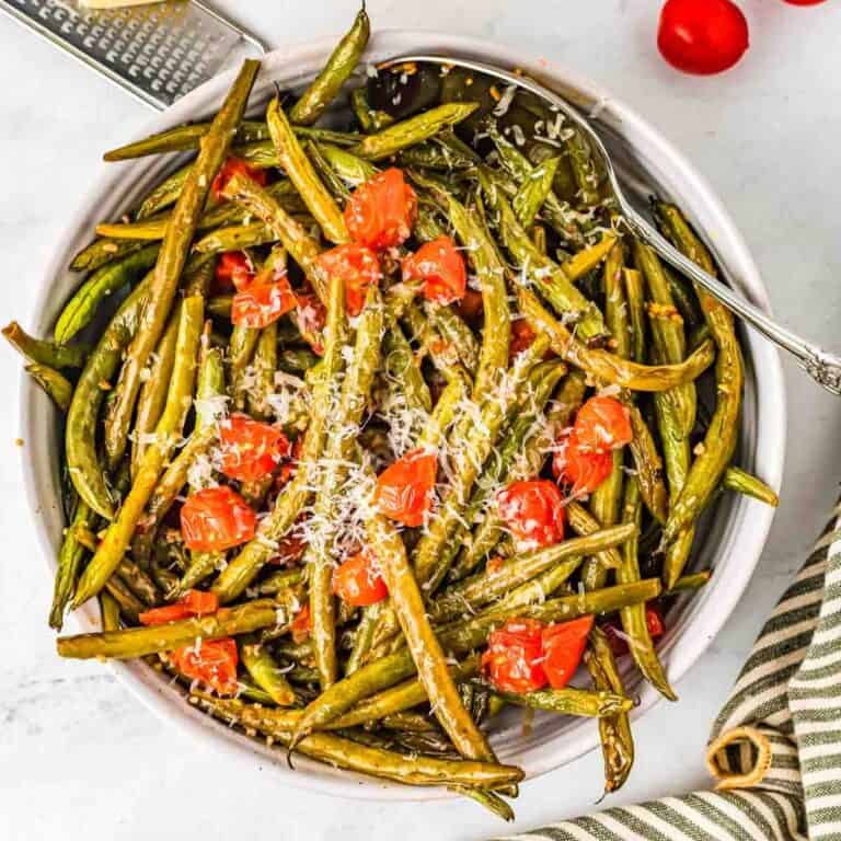 bowl of Italian green beans with a silver spoon in them