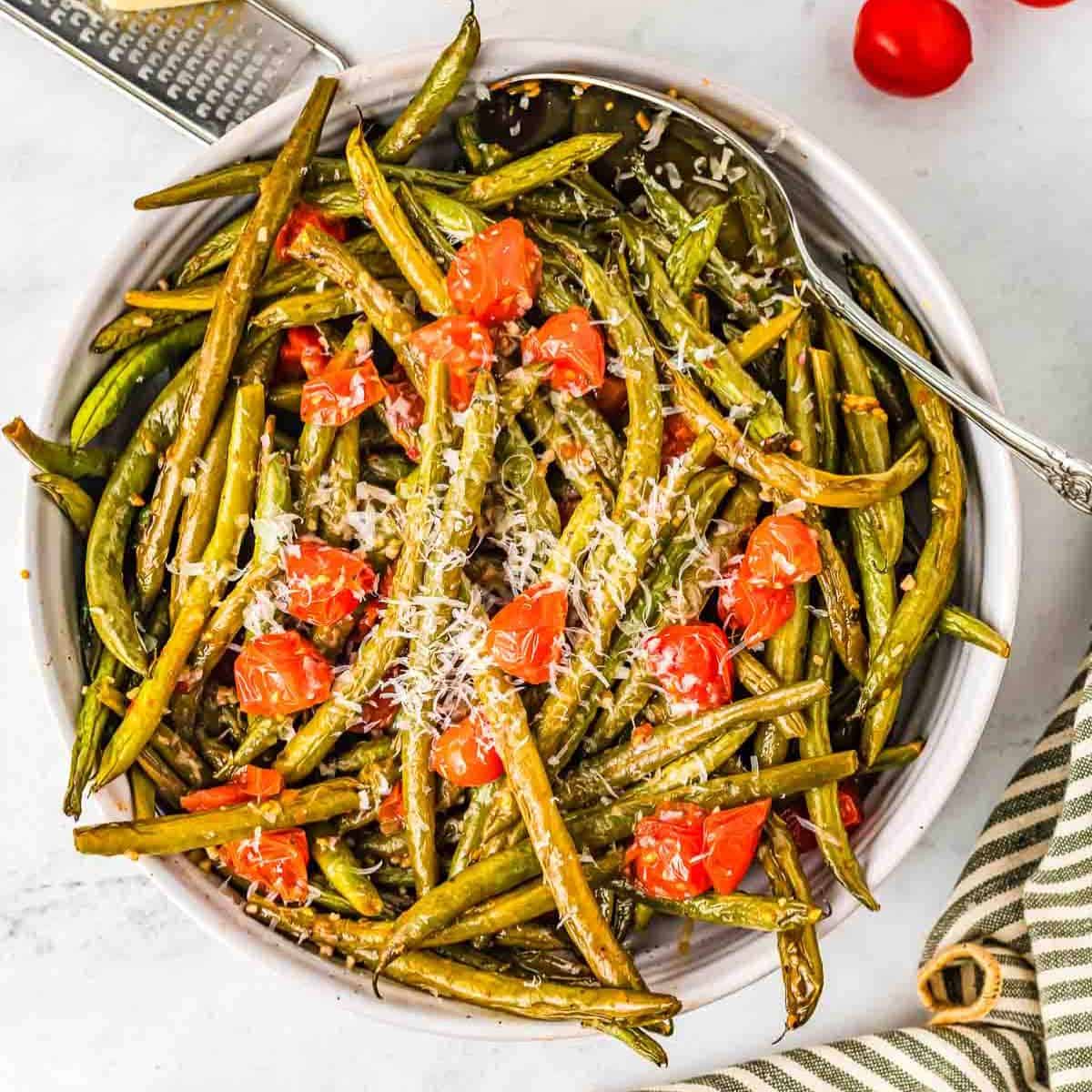 bowl of Italian green beans with a silver spoon in them
