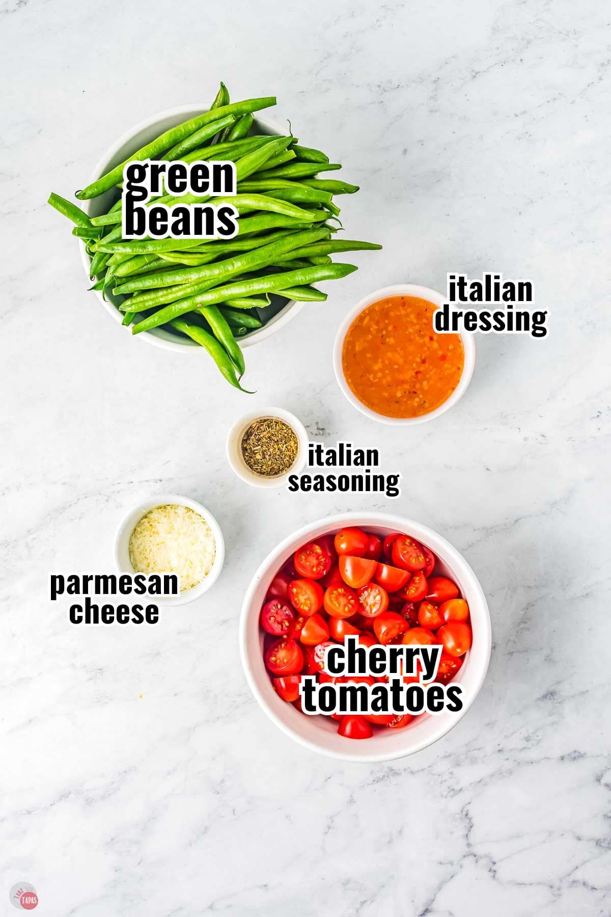 ingredients for a green bean recipe in individual bowls with text overlay labeling them