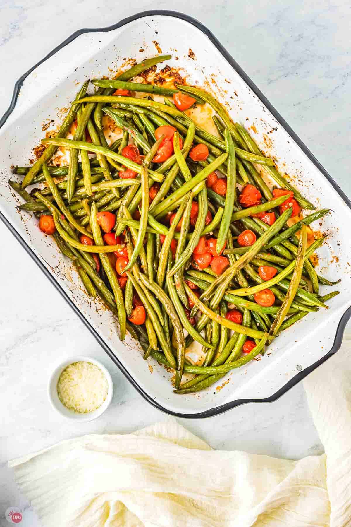roasted Italian green beans and tomatoes in a white dish