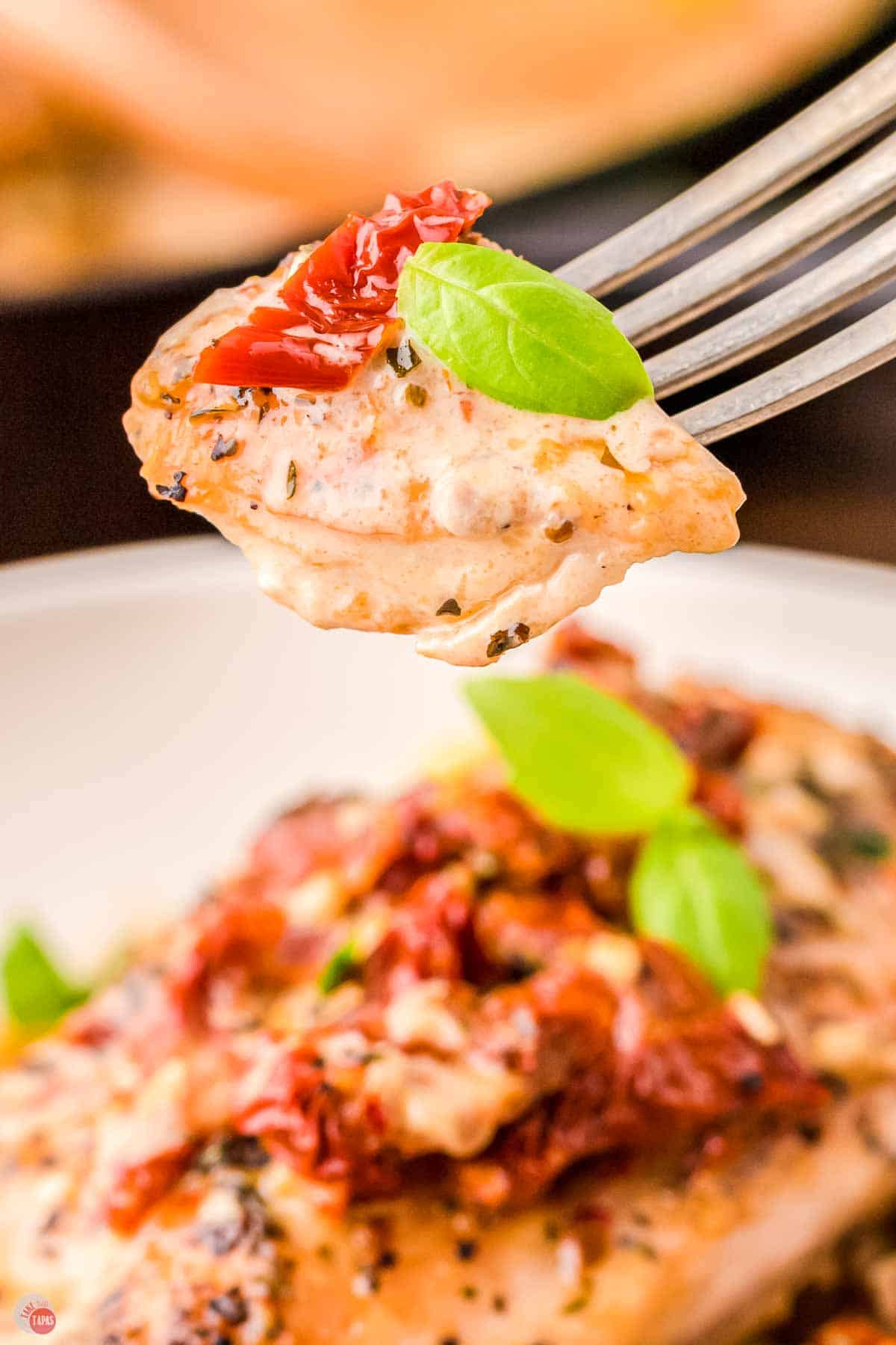 fork with bite of chicken on it