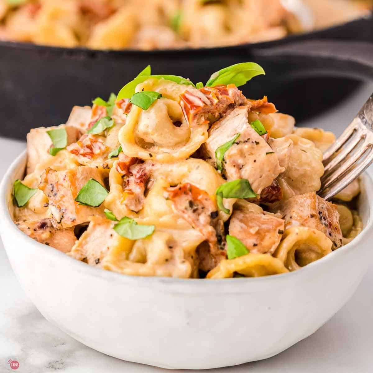 bowl of chicken and cheese tortellini with sauce