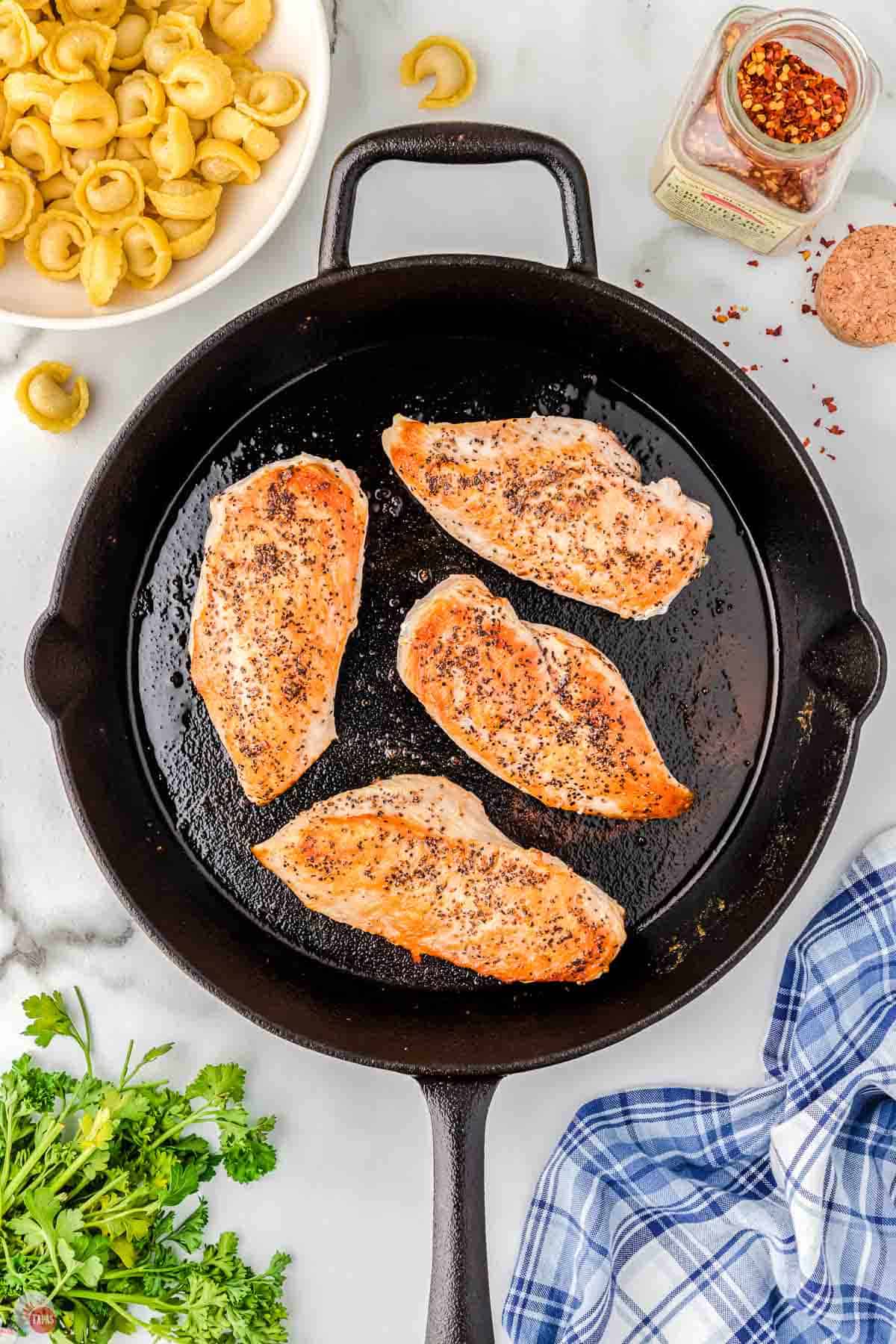 cooked chicken breasts in a cast iron skillet