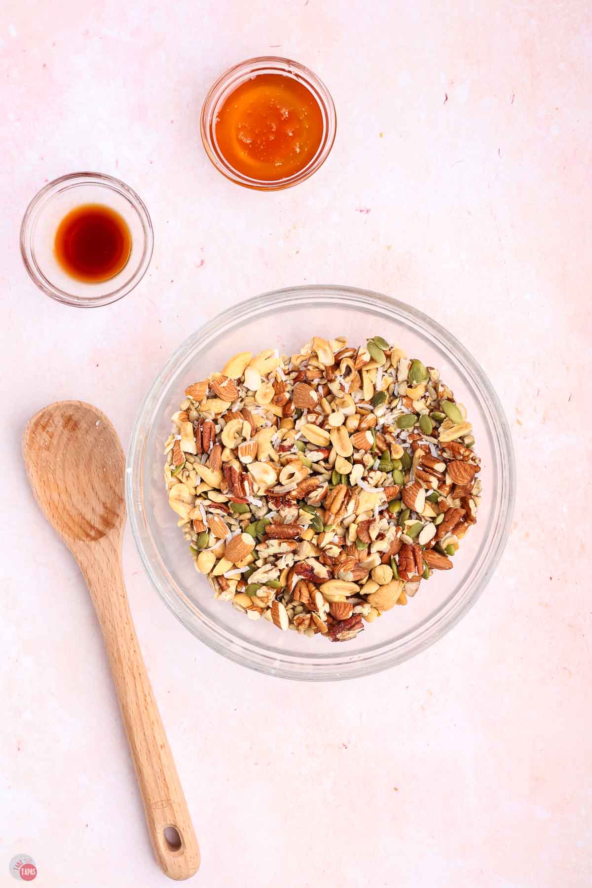 bowl of chopped nuts next to three bowls of seeds
