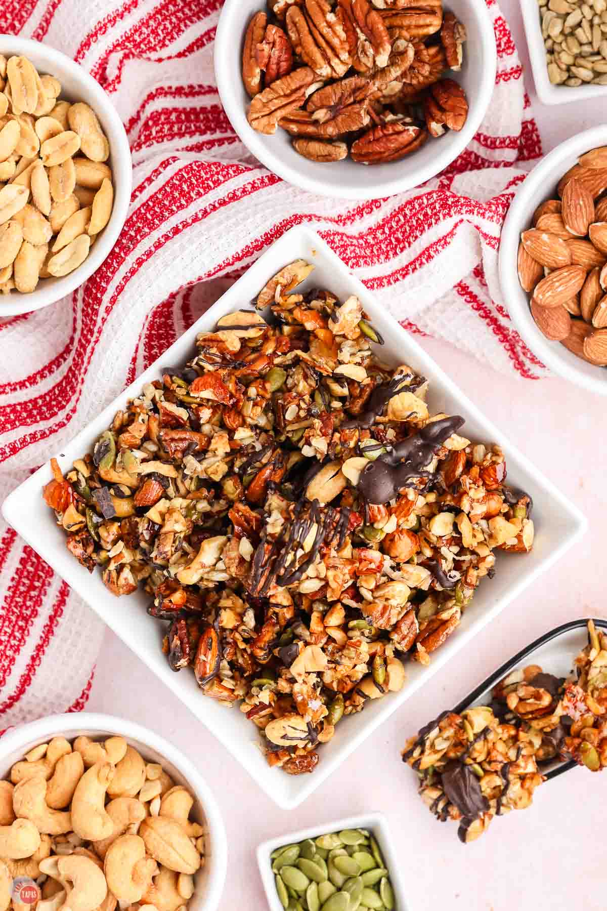 square bowl of toasted nuts and chocolate