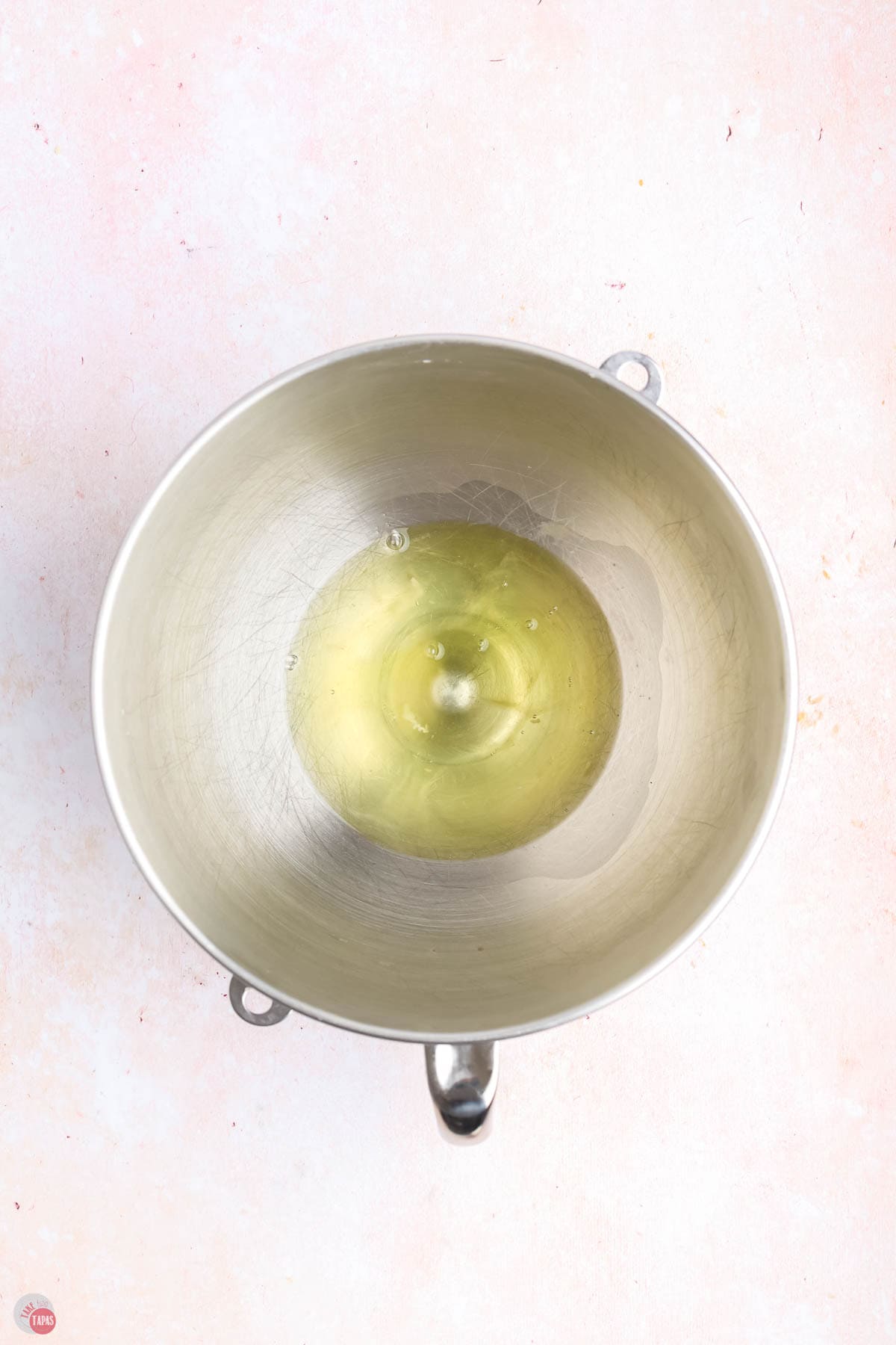 egg whites in a silver mixing bowl