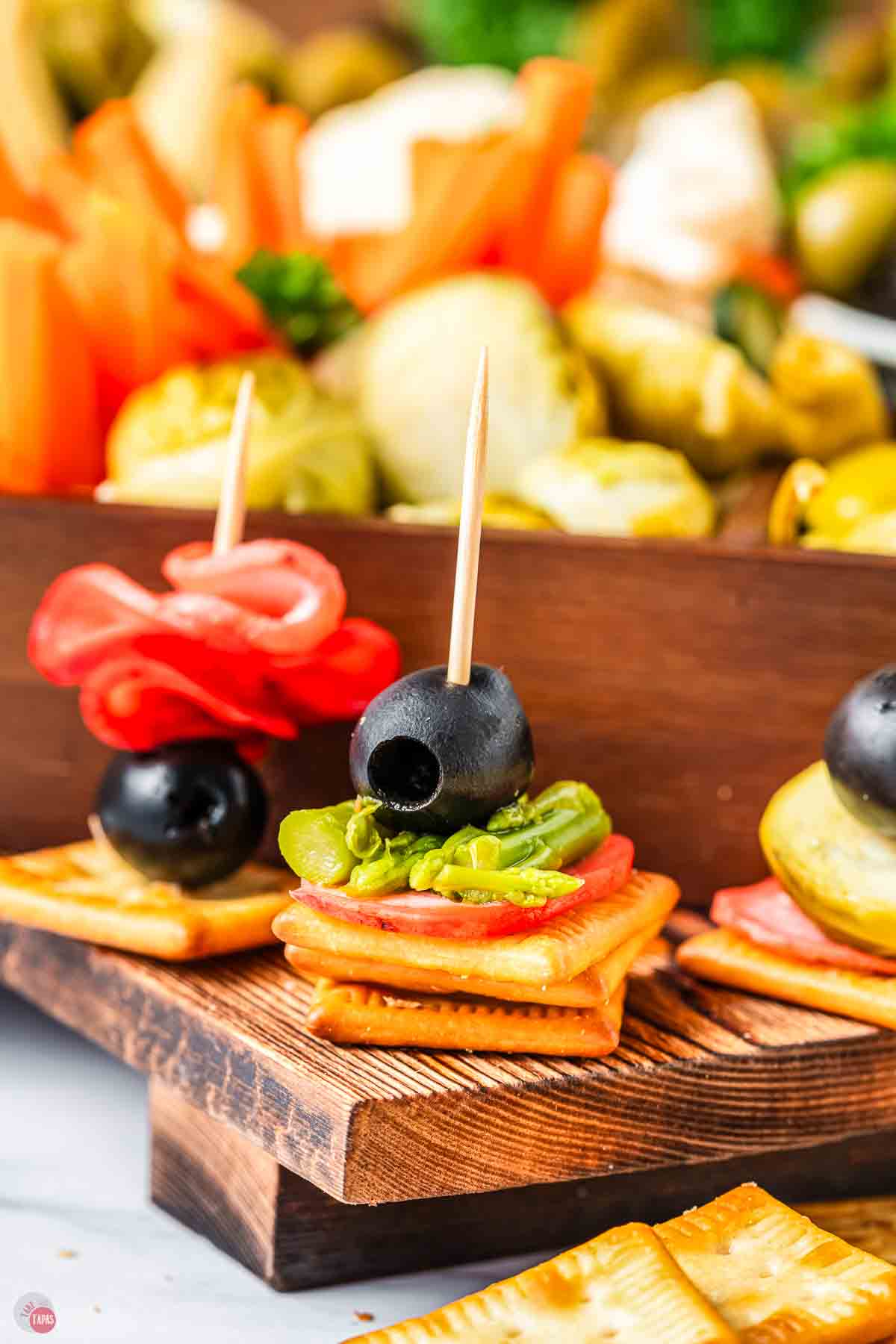 cracker stack with guacamole and olives