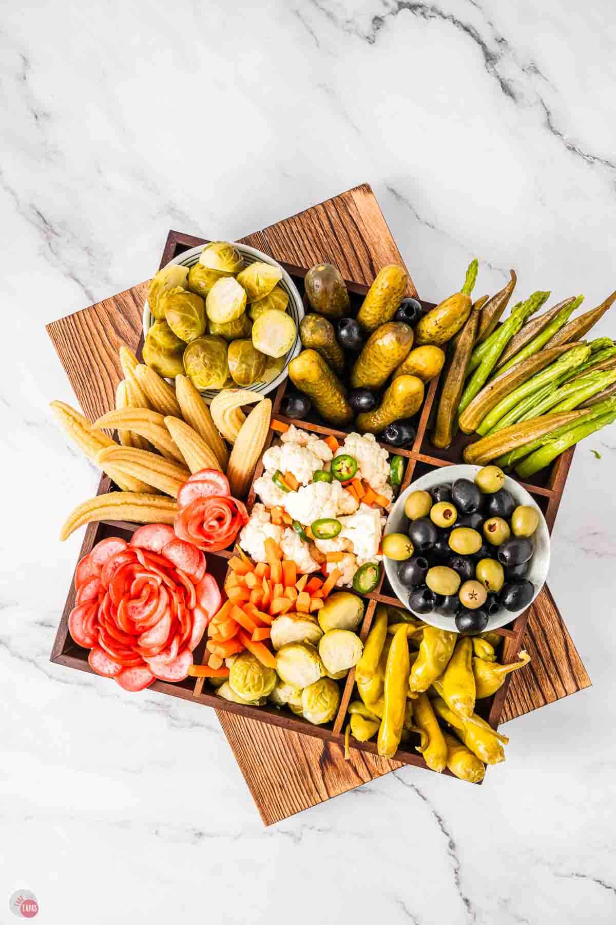 relish tray with foods arranged in a wood box