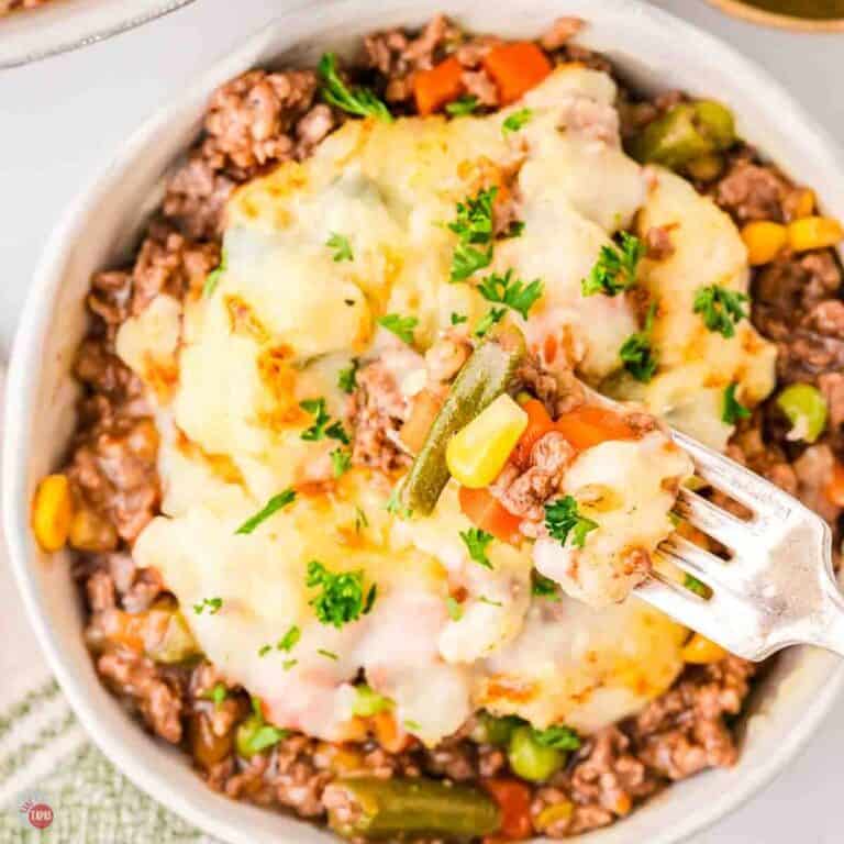 bowl of shepherds pie with a fork taking out a bite