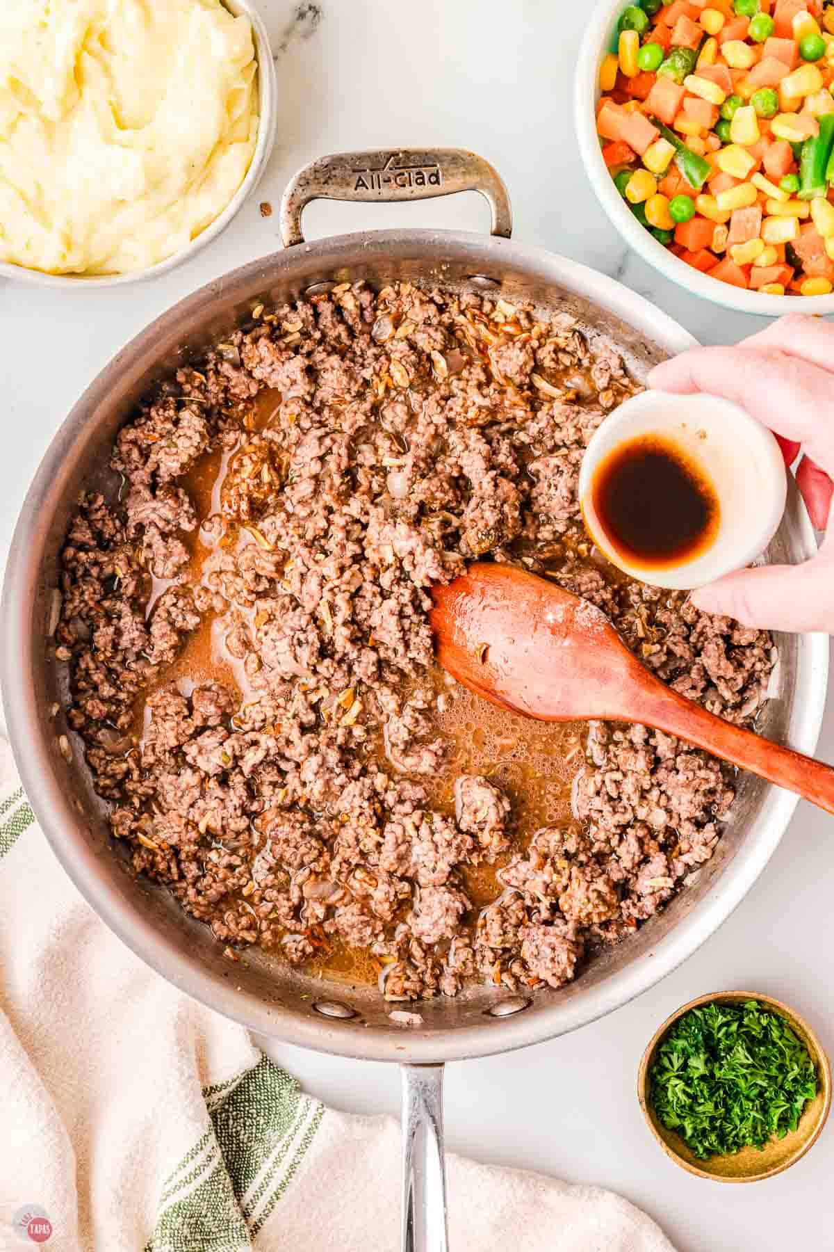 cooked ground beef and broth in a skillet