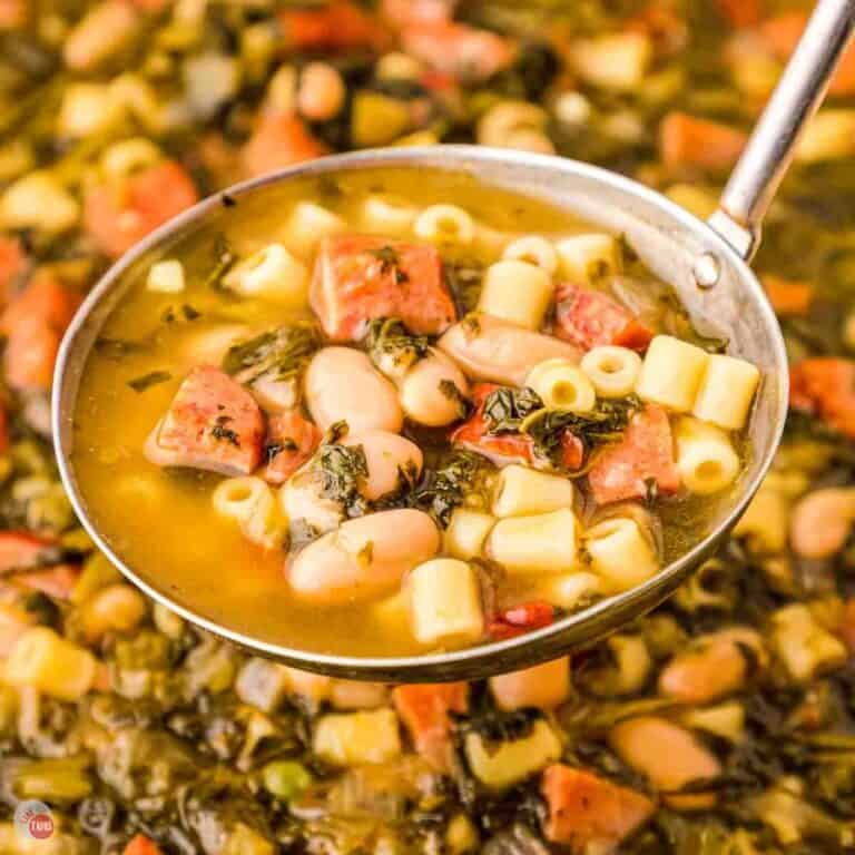 ladle of soup with ham and collard greens