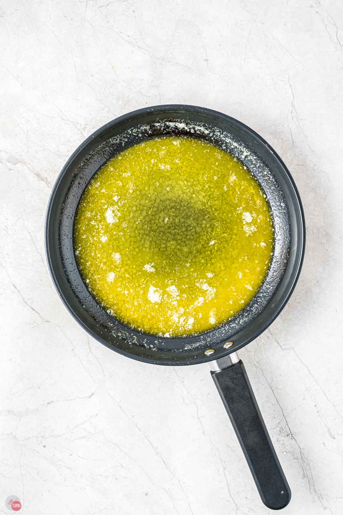 skillet with melted butter in it