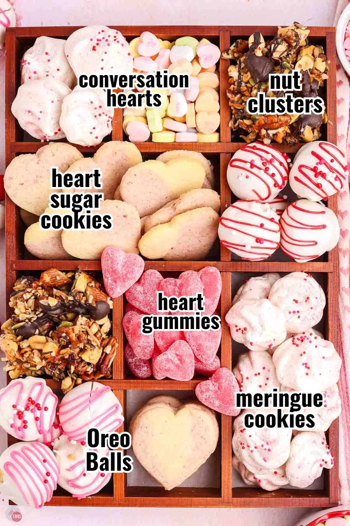 wood box with candy and cookies in it each compartment