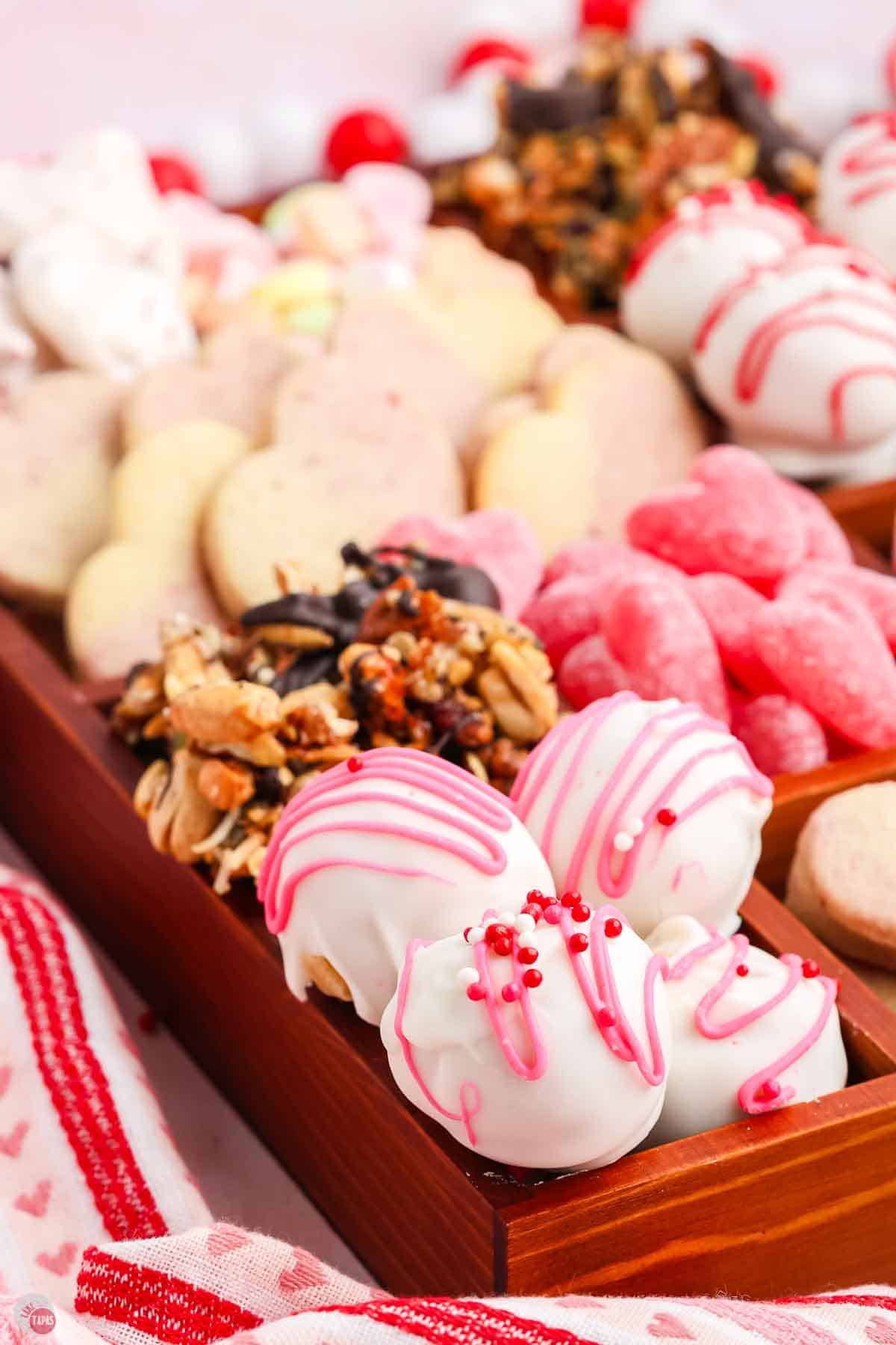 pink, red, and white truffles in a box