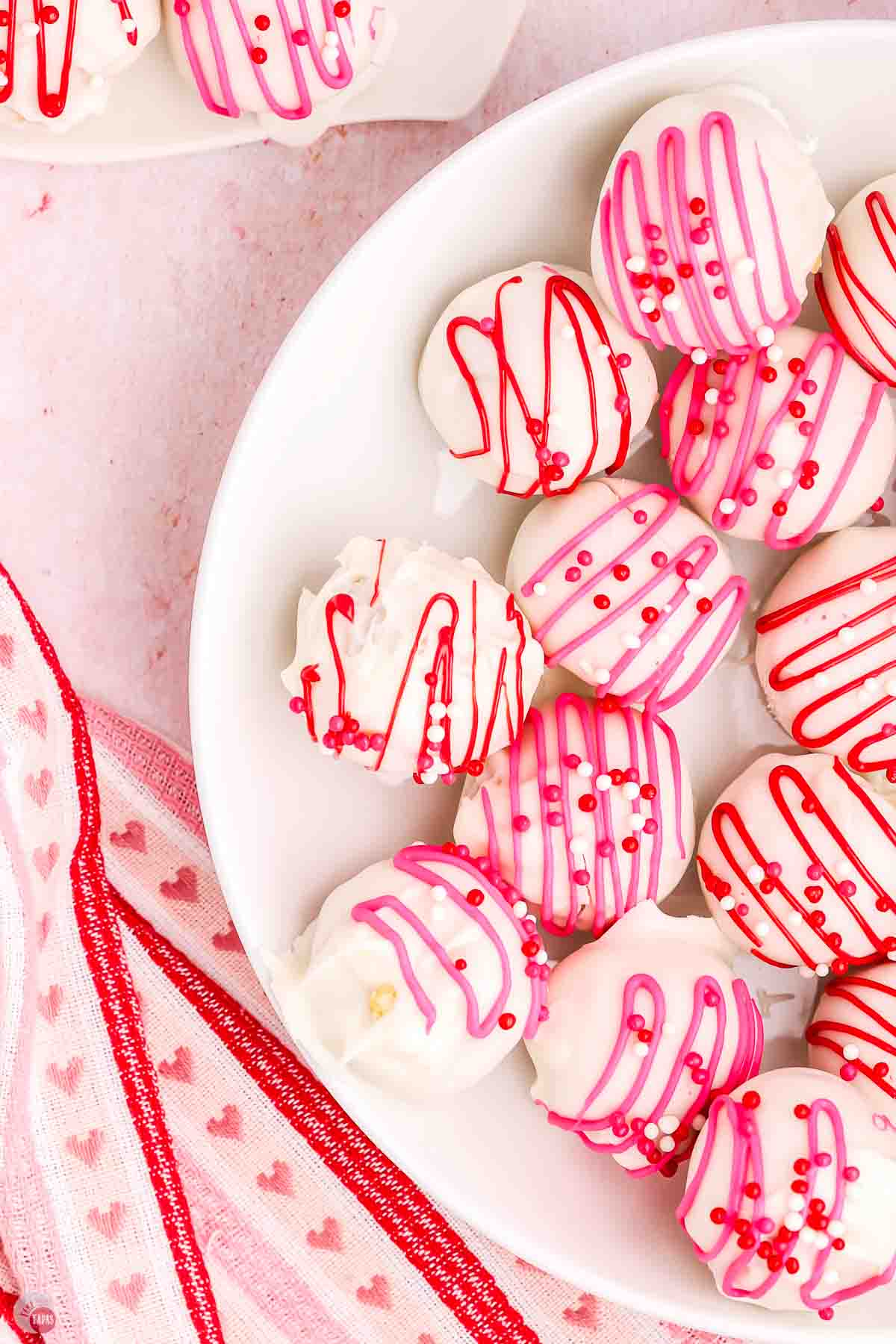 close up of Oreo balls with pink and white icing