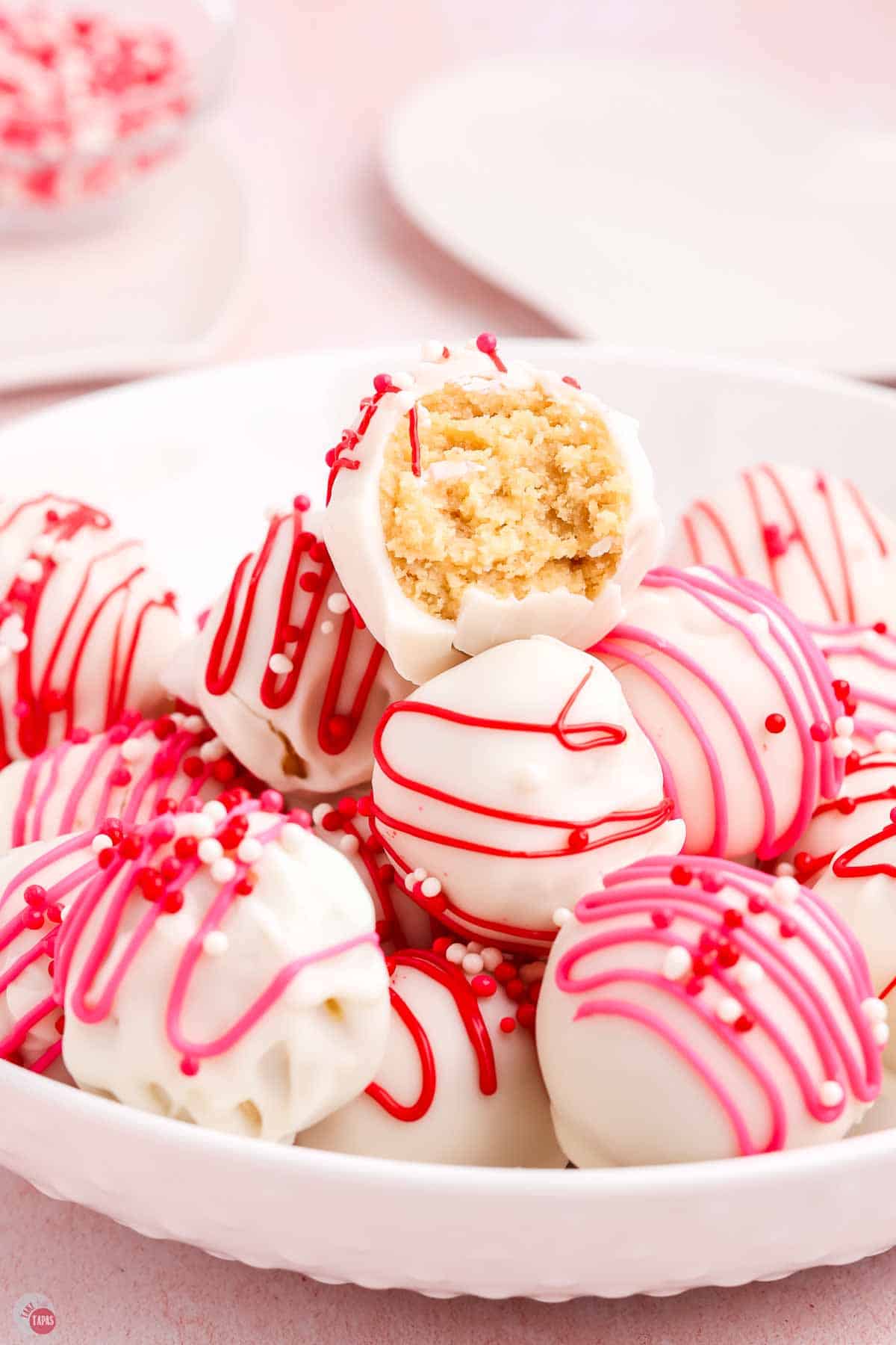 stack of red and white oreo balls with a bite missing from one