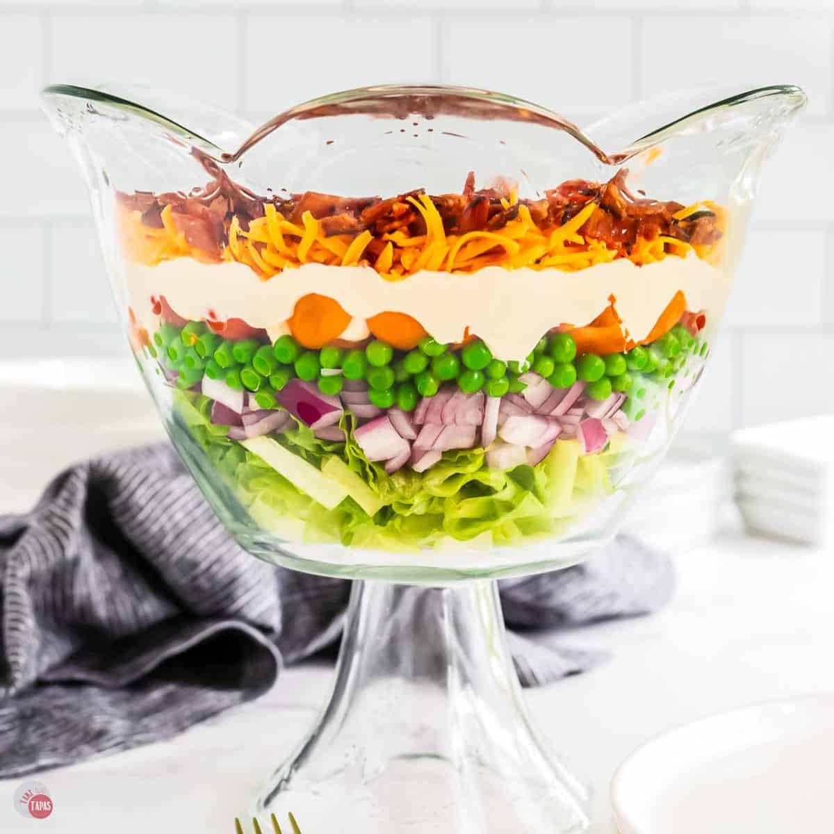 clear bowl with a 7 layer salad in it