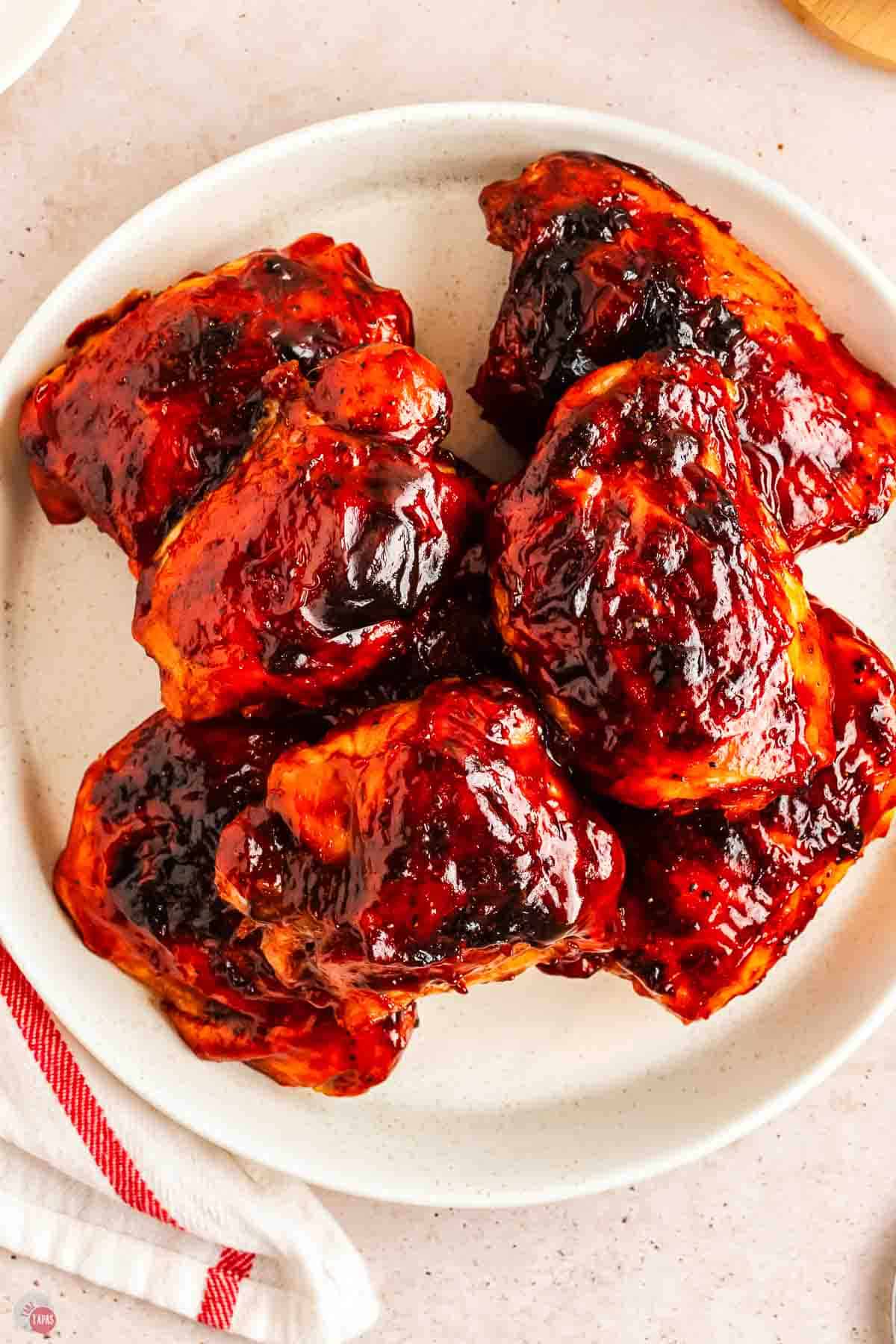 close up of plate of bbq chicken thighs baked in the oven