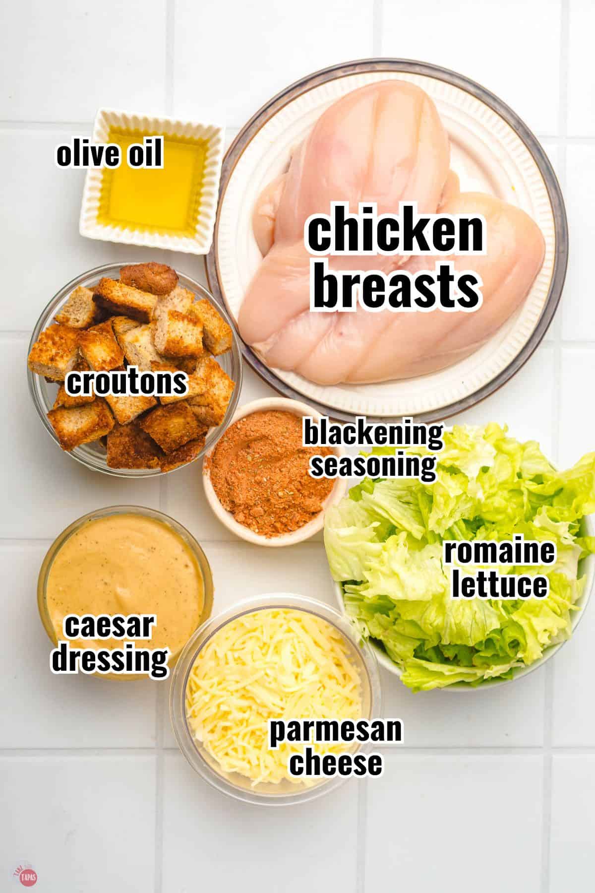 ingredients for a salad recipe in individual bowls with text overlay labeling them