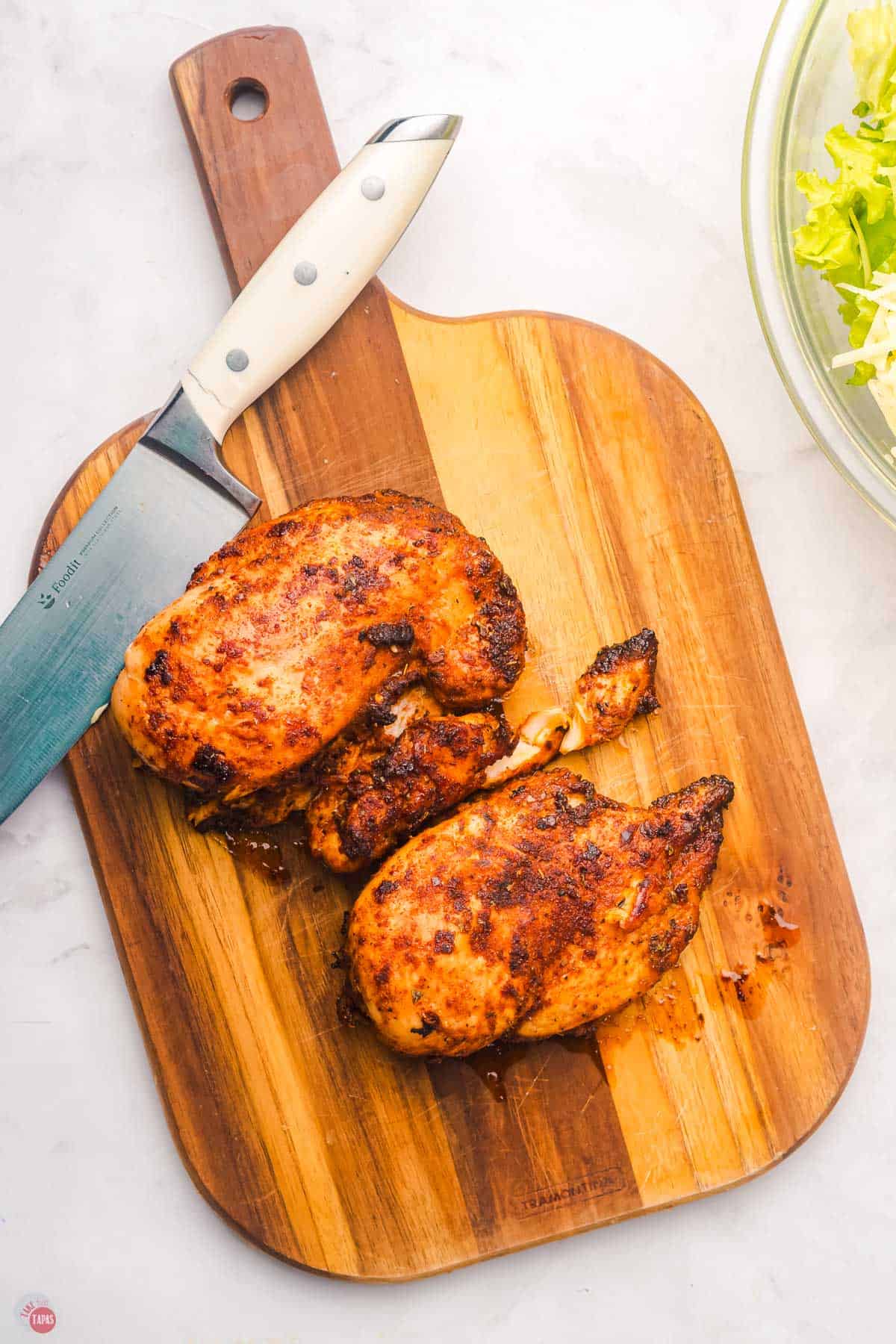 chicken breasts on a cutting board covered with blackening seasoning