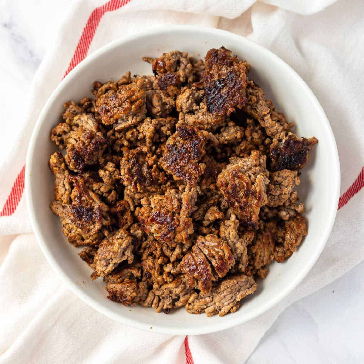 browned ground beef in a white bowl