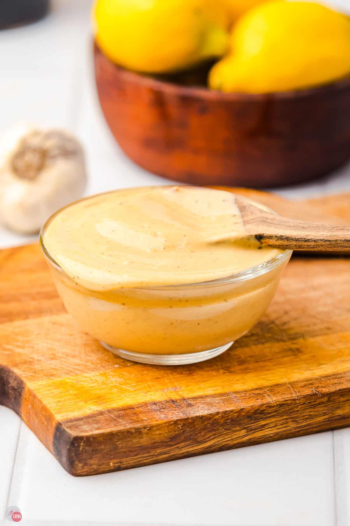 clear bowl of caesar salad dressing