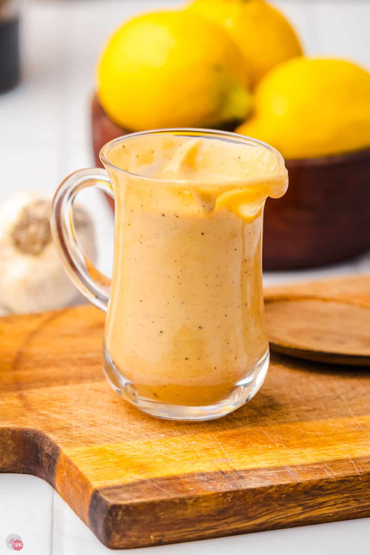 small clear dispenser with homemade salad dressing