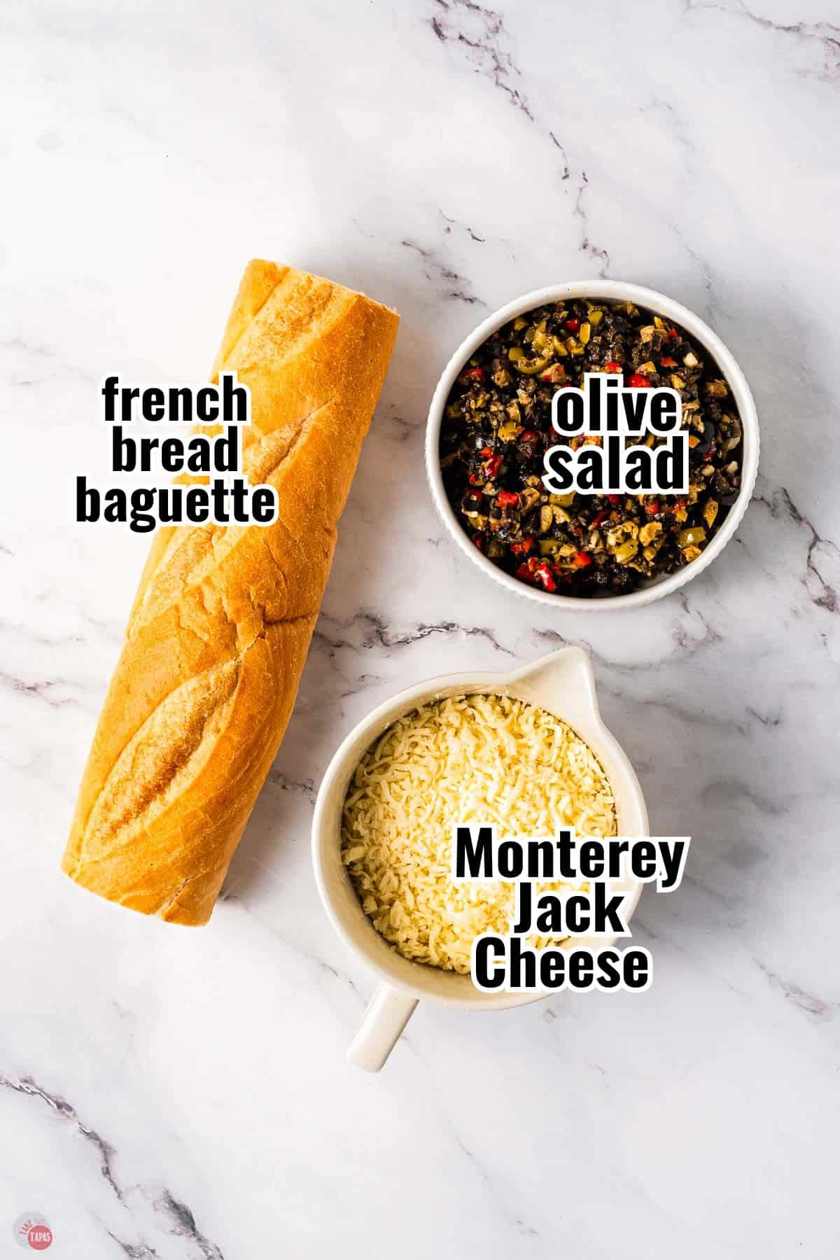 ingredients for a French bread appetizer on a marble counter with text overlay labeling them