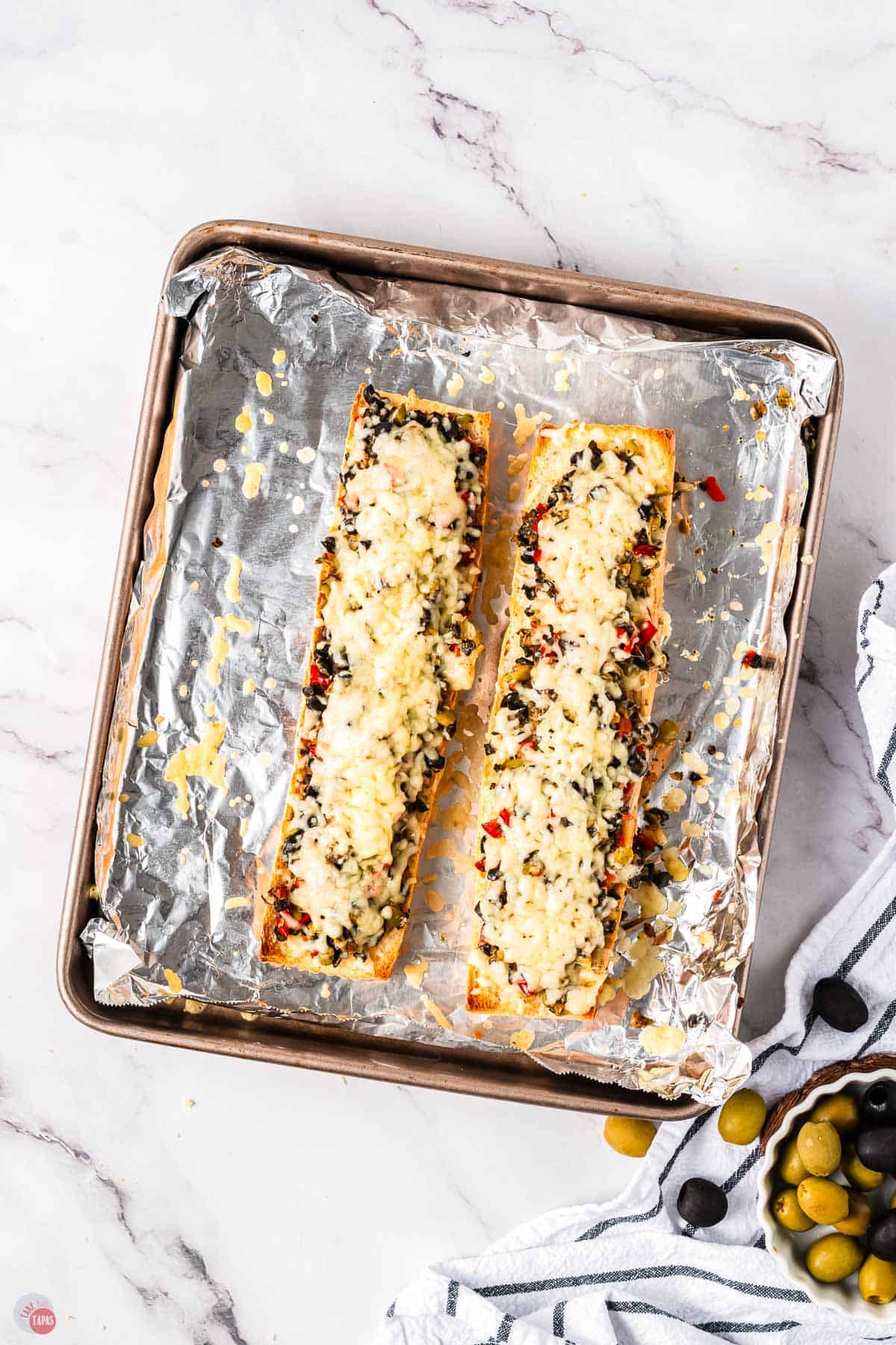 baked cheese bread on a baking sheet with foil